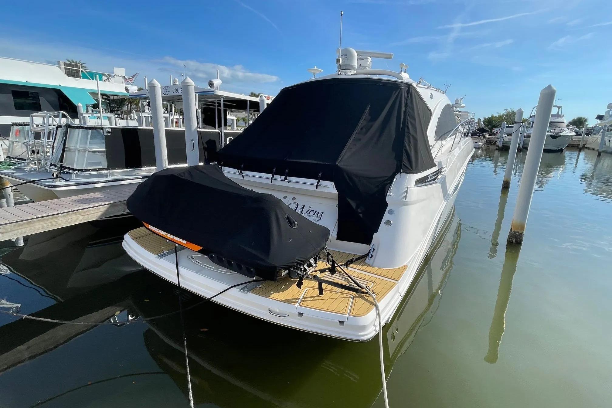 2016 Sea Ray Sundancer 510 yacht docked at marina under clear blue sky.