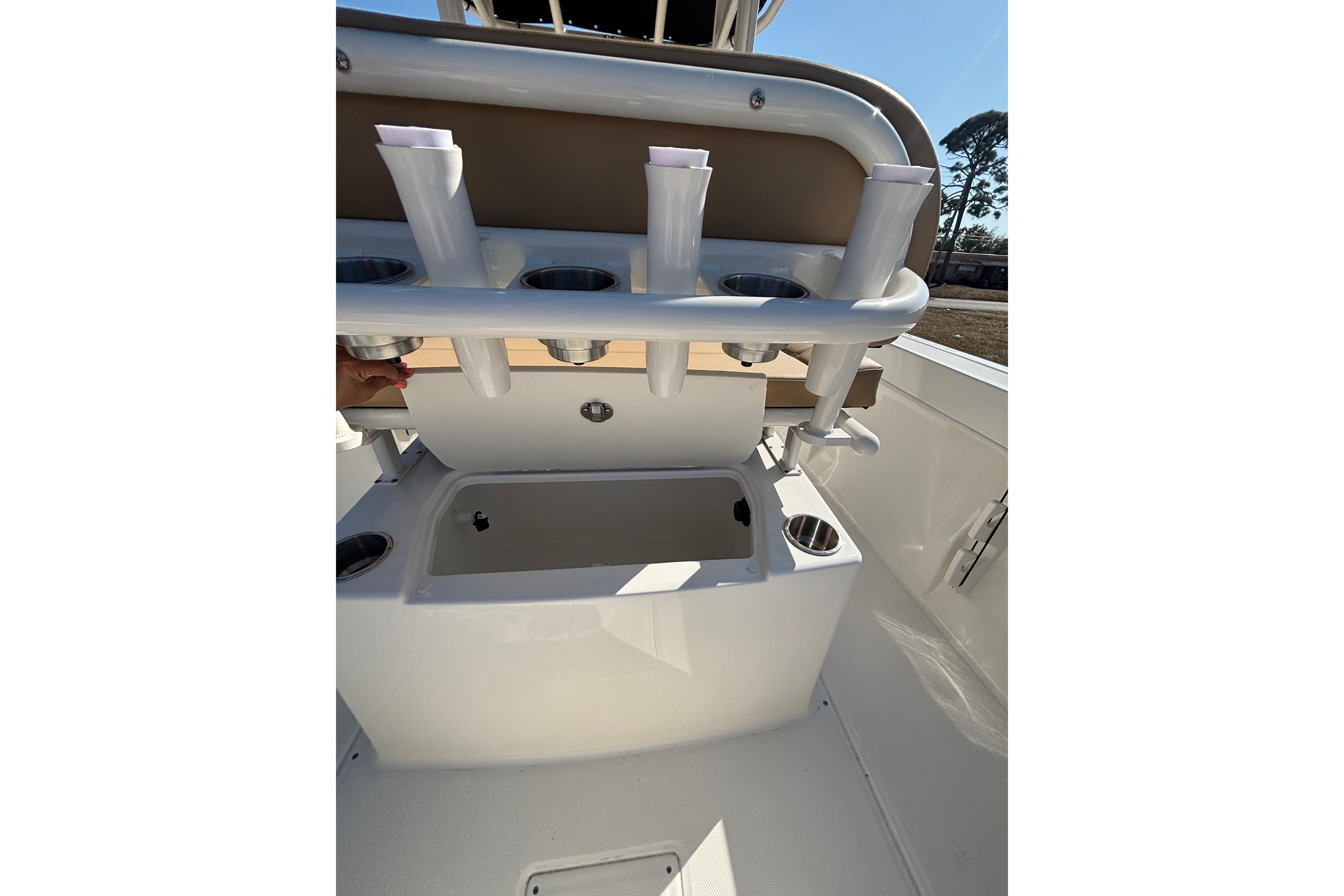2026 Bayliner Trophy T22CC boat interior with rod holders and storage compartment.