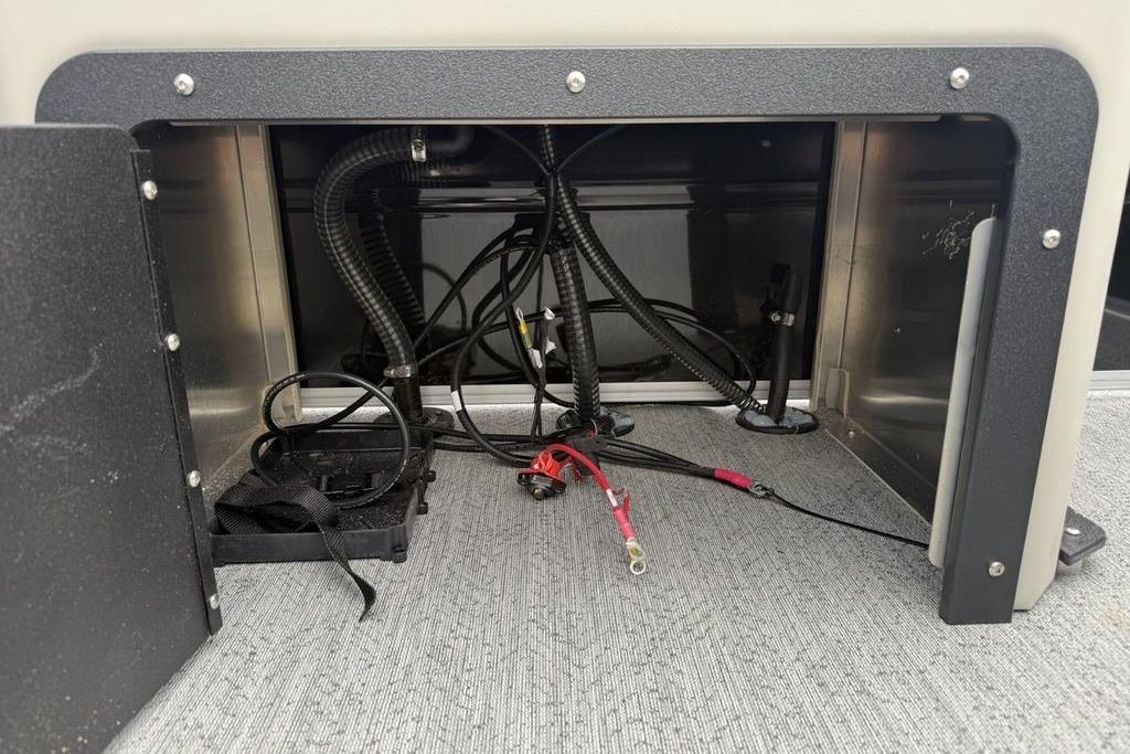 2026 Sun Tracker Fishin' Barge 20 DLX interior wiring compartment with cables and connectors.
