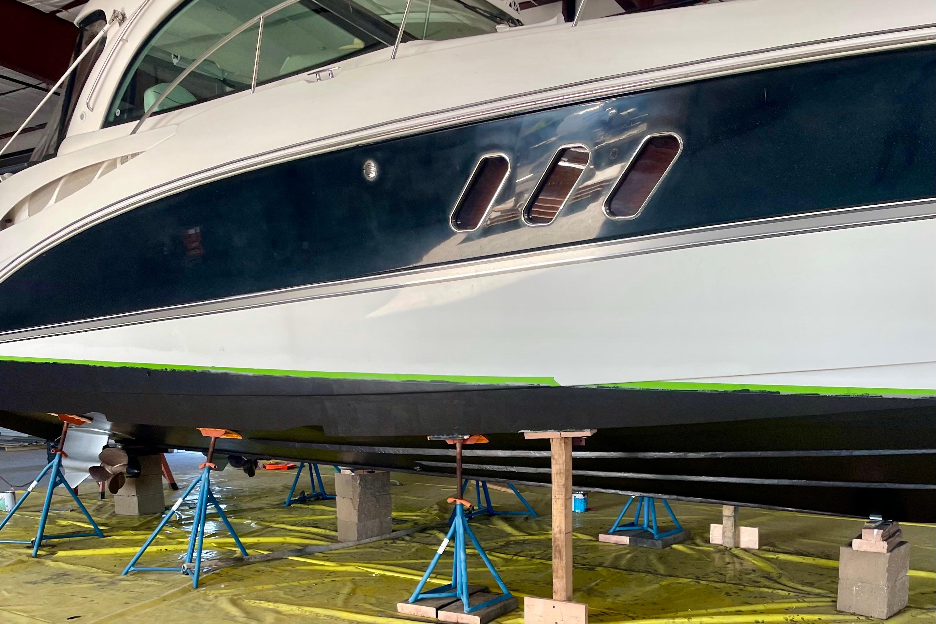 2011 Cruisers Yachts 390 Sports Coupe on stands in a maintenance facility.
