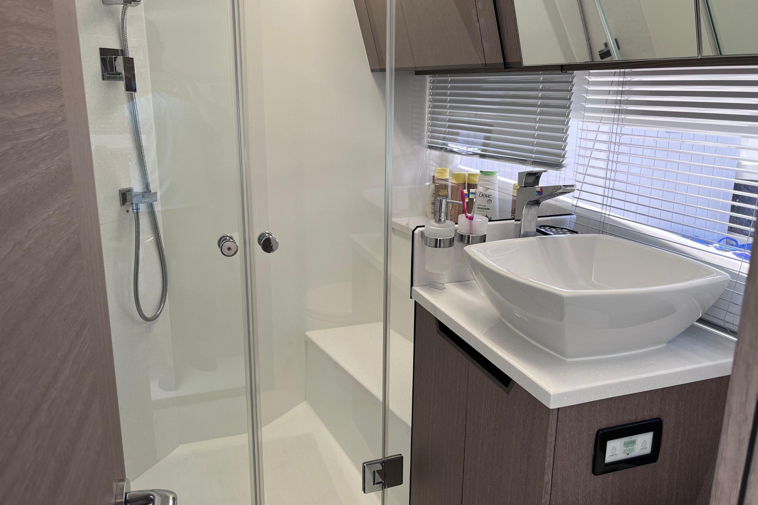 Modern bathroom in 2024 Galeon 425 HTS yacht with sleek shower and stylish sink.