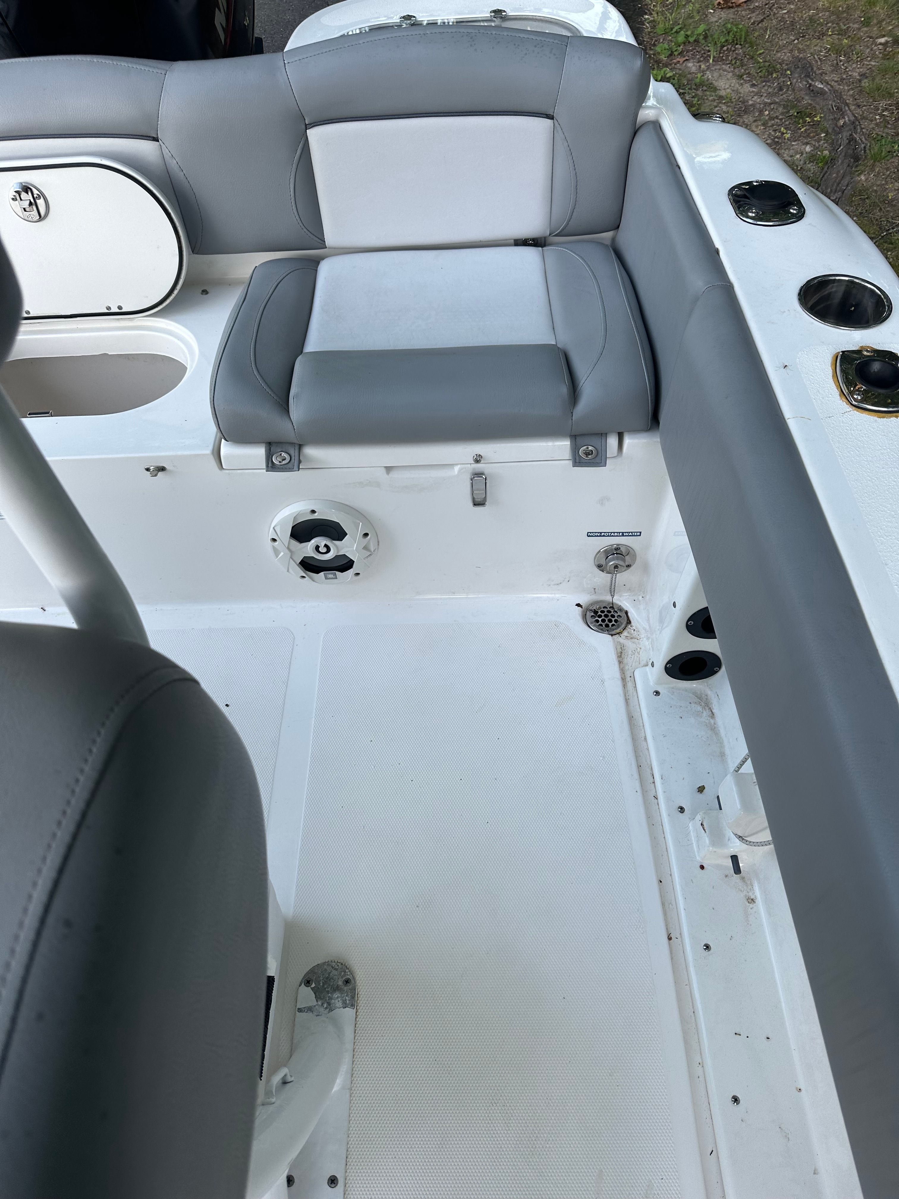 The image shows the interior of a 2022 NauticStar 2102 Legacy boat with gray seating.