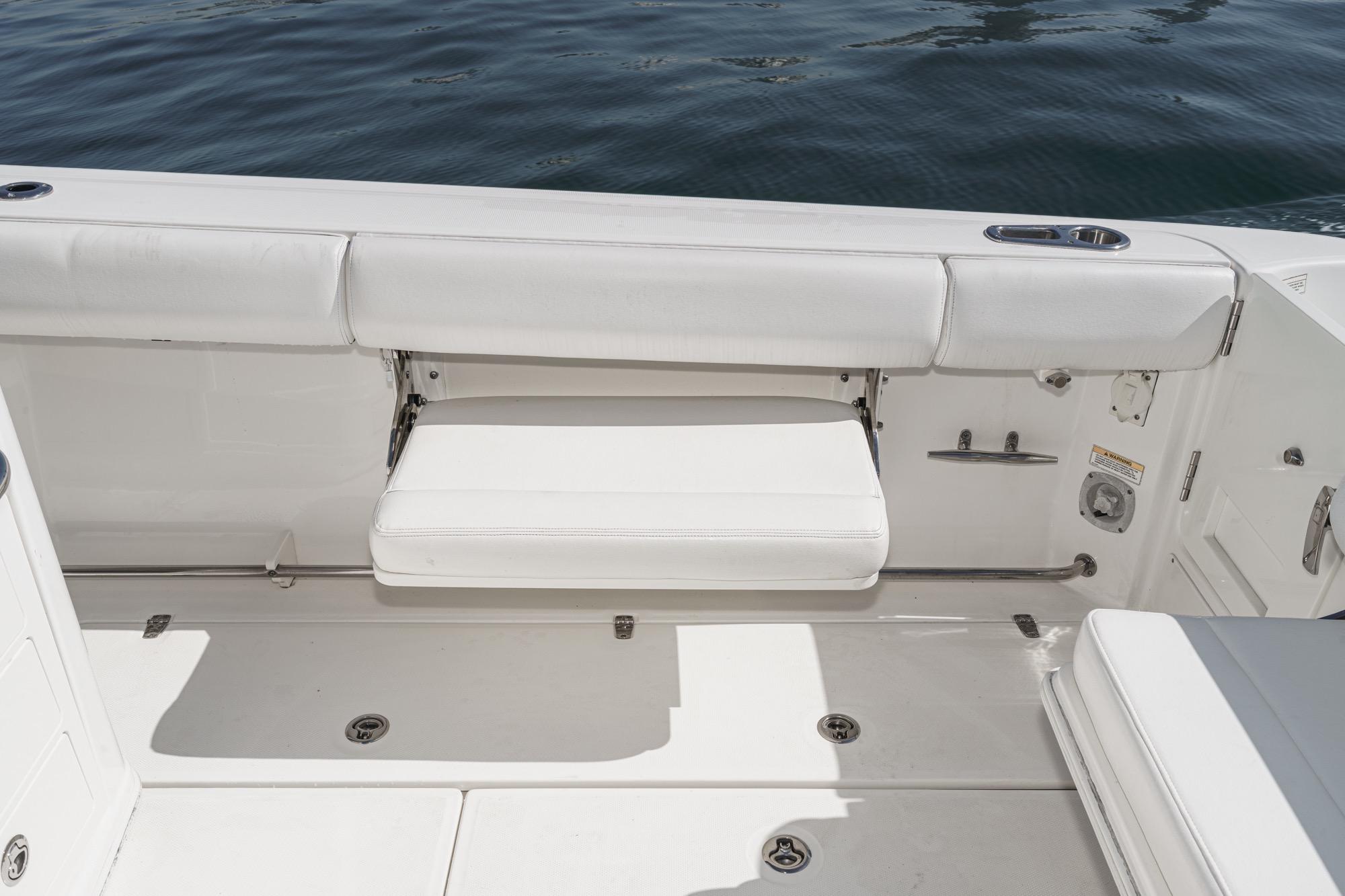 2015 Boston Whaler 370 Outrage boat interior with white seating and ocean backdrop.