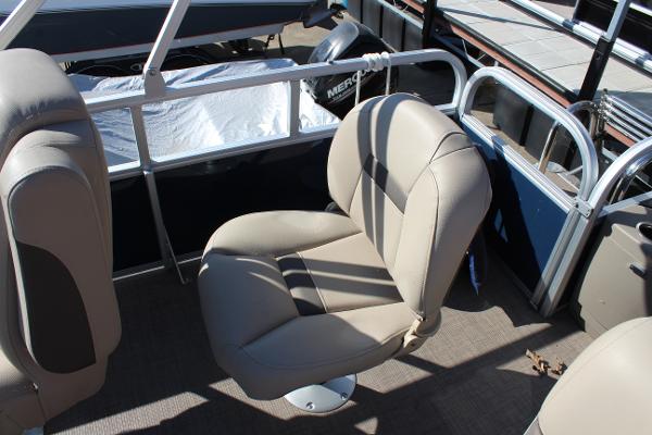 2024 Sun Tracker BB18 boat interior with beige seating and railing.