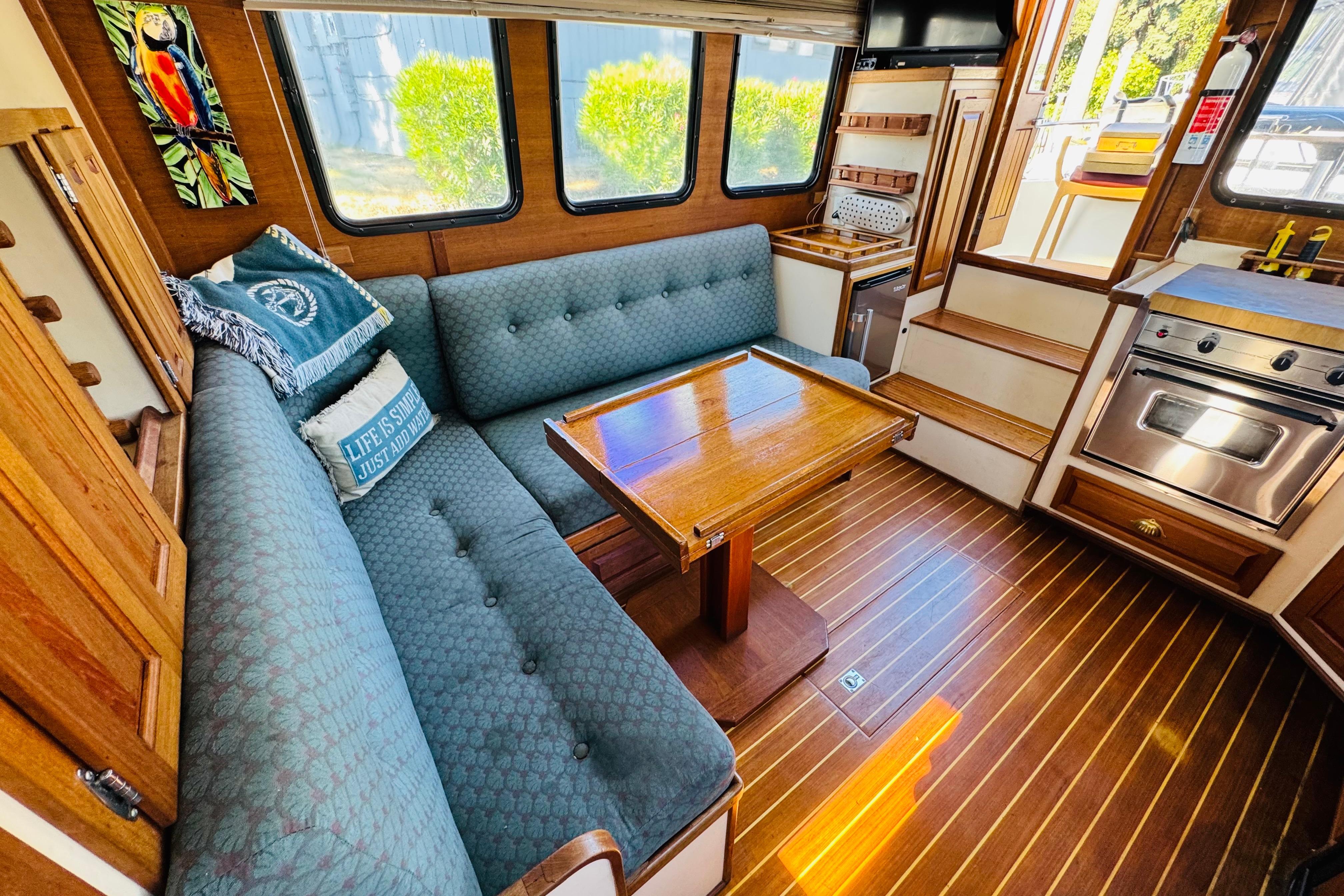 Cozy interior of a 1996 Nordic Tug 32 with wood accents and comfortable seating.