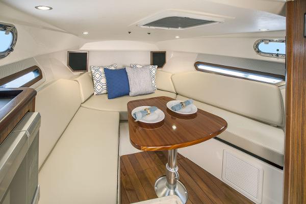 Manufacturer Provided Image: 2021 Pursuit OS 325 Offshore cabin with dining table and cushioned seating.