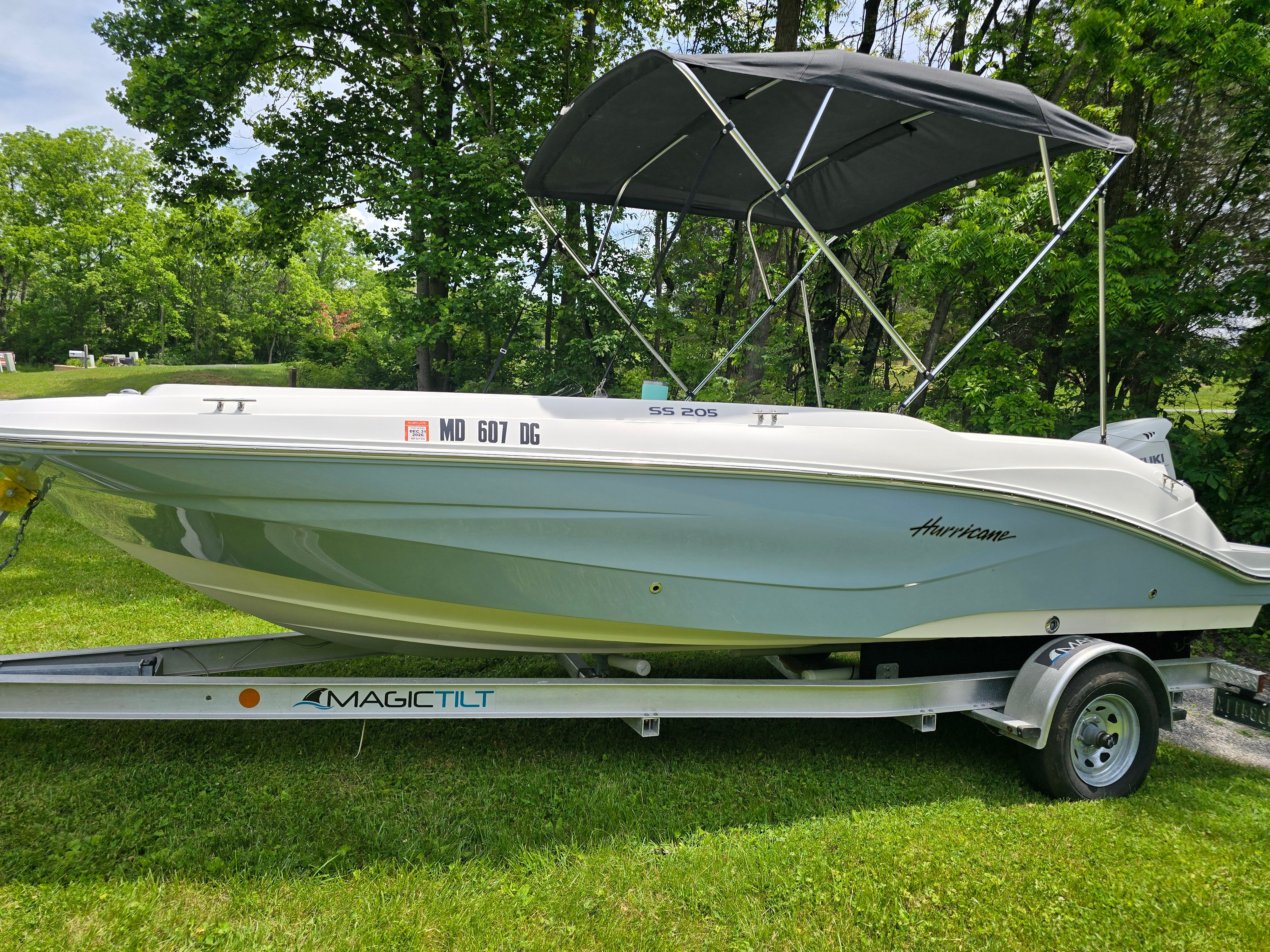 2021 Hurricane 205SS boat on trailer in a grassy area.