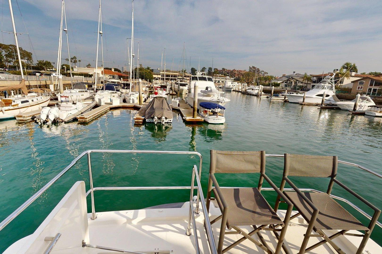 Beneteau Swift Trawler 35, 2021, docked in a marina with surrounding boats.