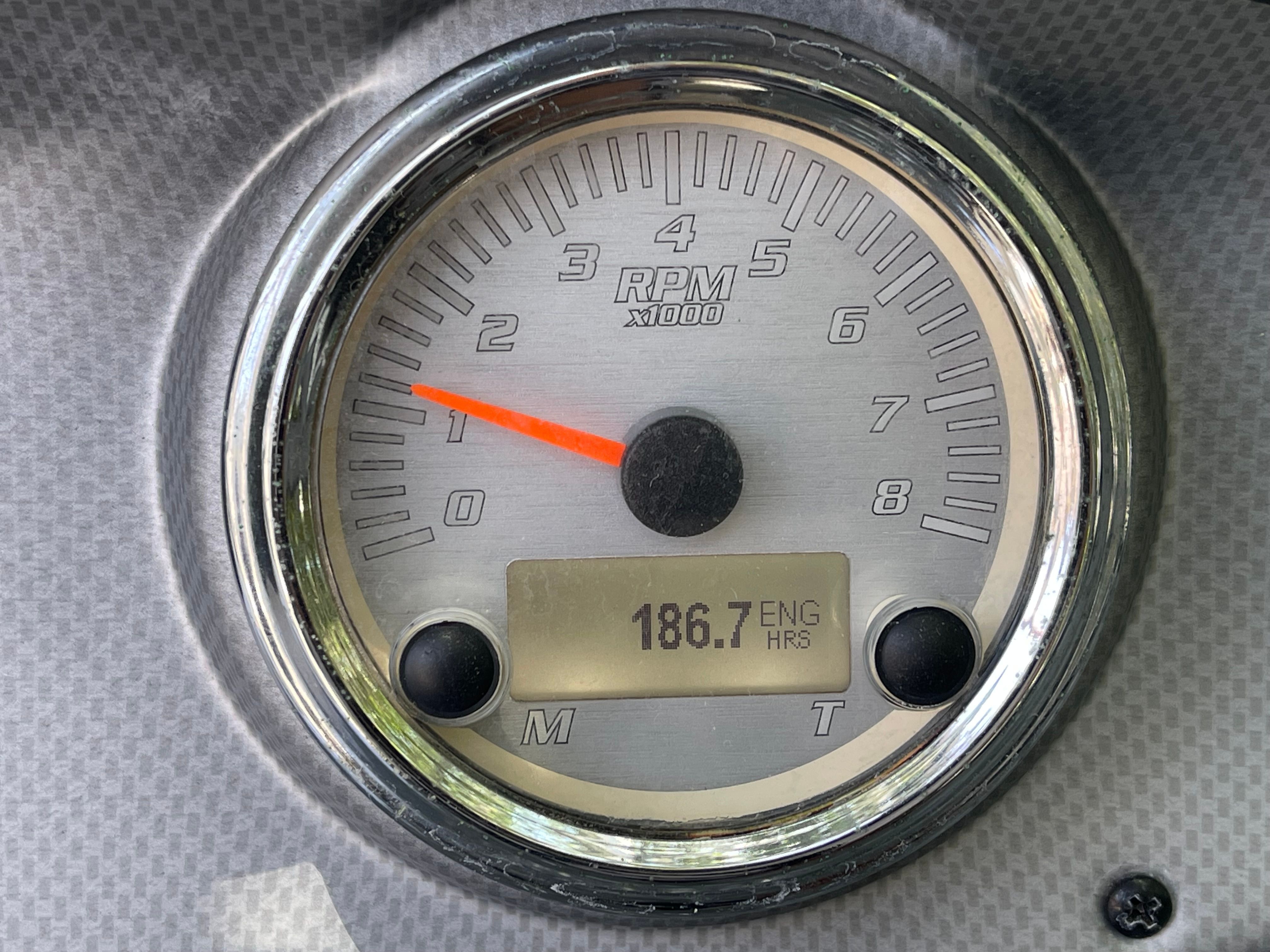 A tachometer displays 186.7 engine hours.