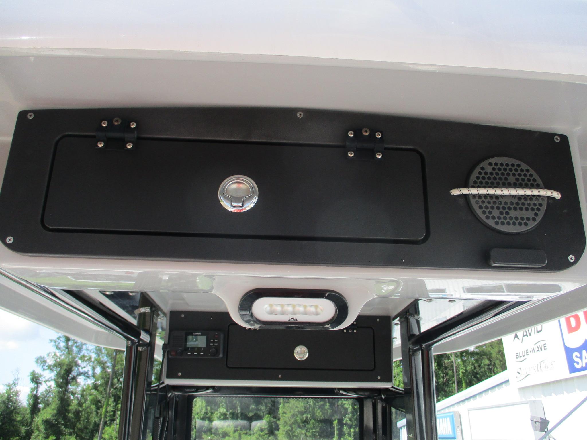 2024 Blue Wave 2800 Makaira boat interior with storage compartment and speaker.