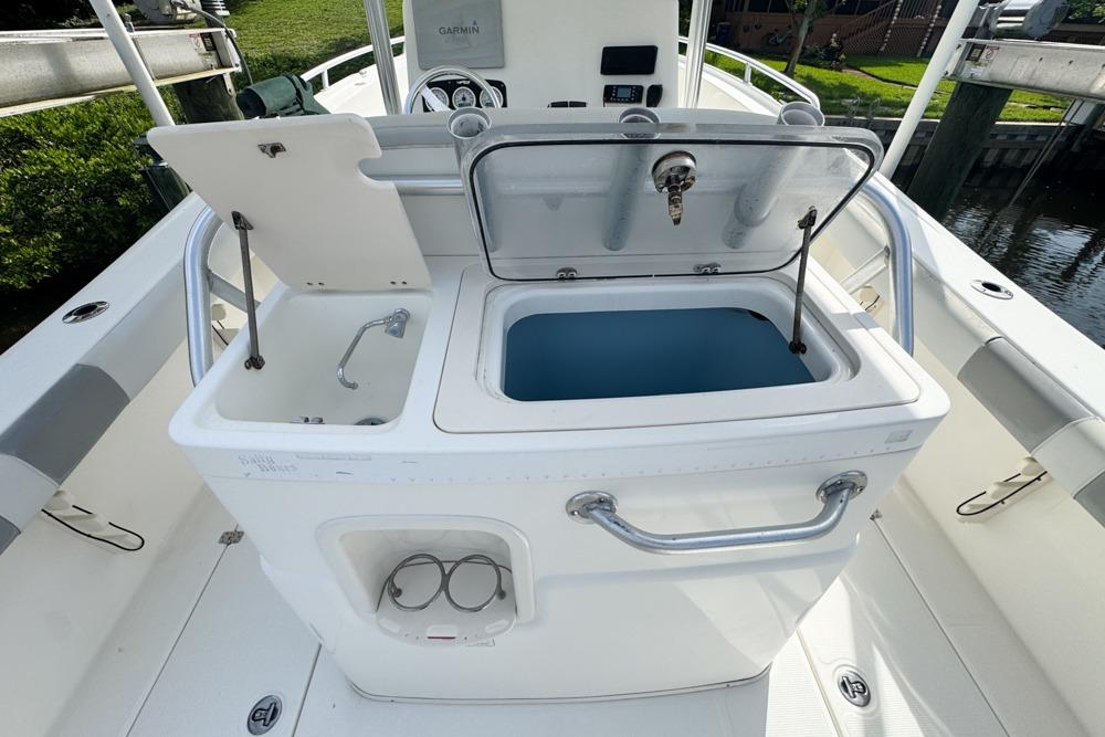 2018 Mako 284 Center Console boat with open storage compartments and sleek design.
