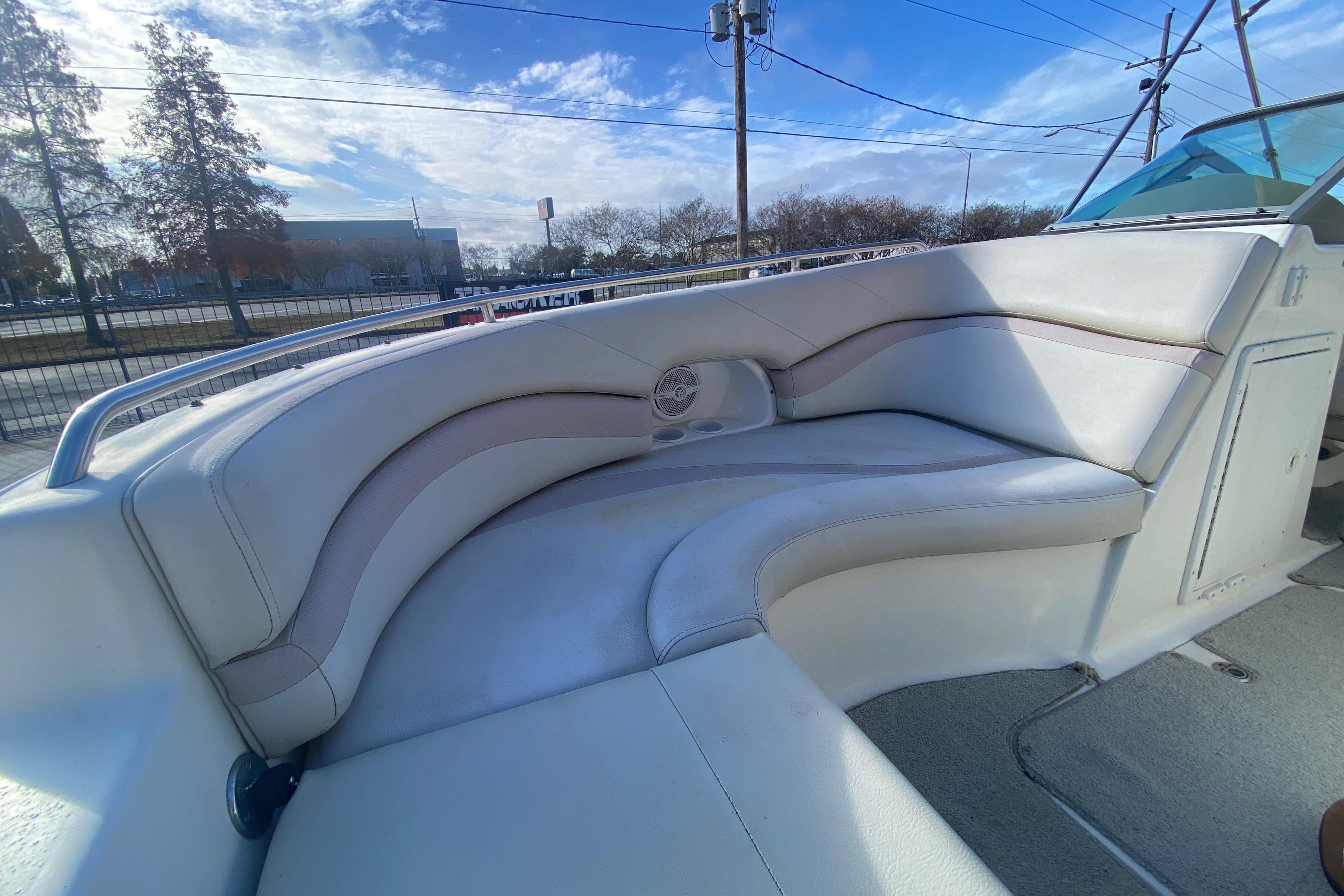 2007 NauticStar 230DC Sport Deck boat interior with cushioned seating and cup holders.