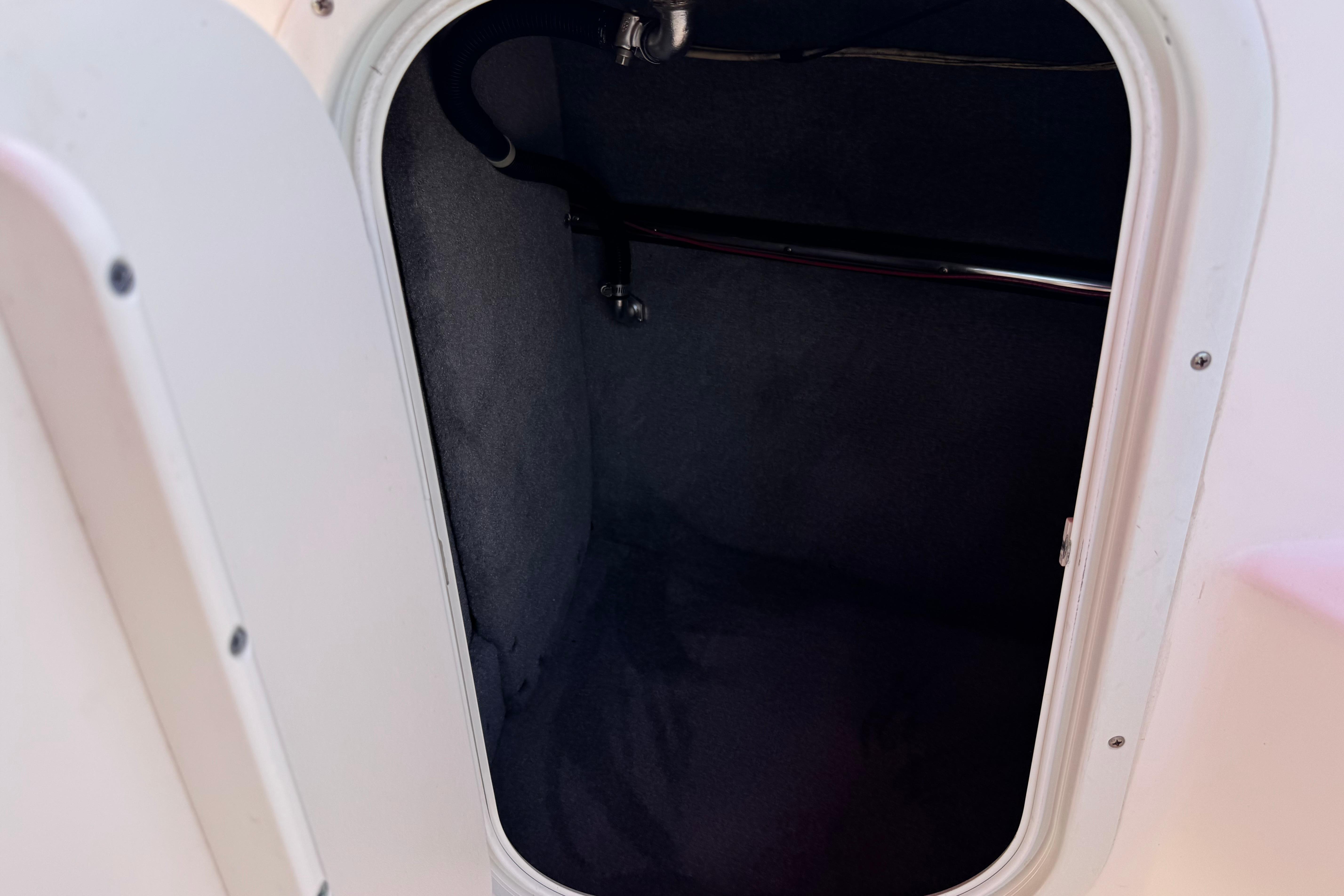 Open storage compartment in a 2010 Bryant 255 boat.