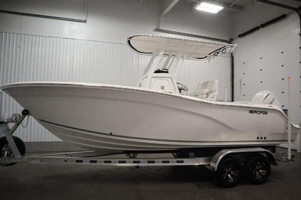 2025 Sea Fox 228 Commander boat on trailer in indoor showroom.