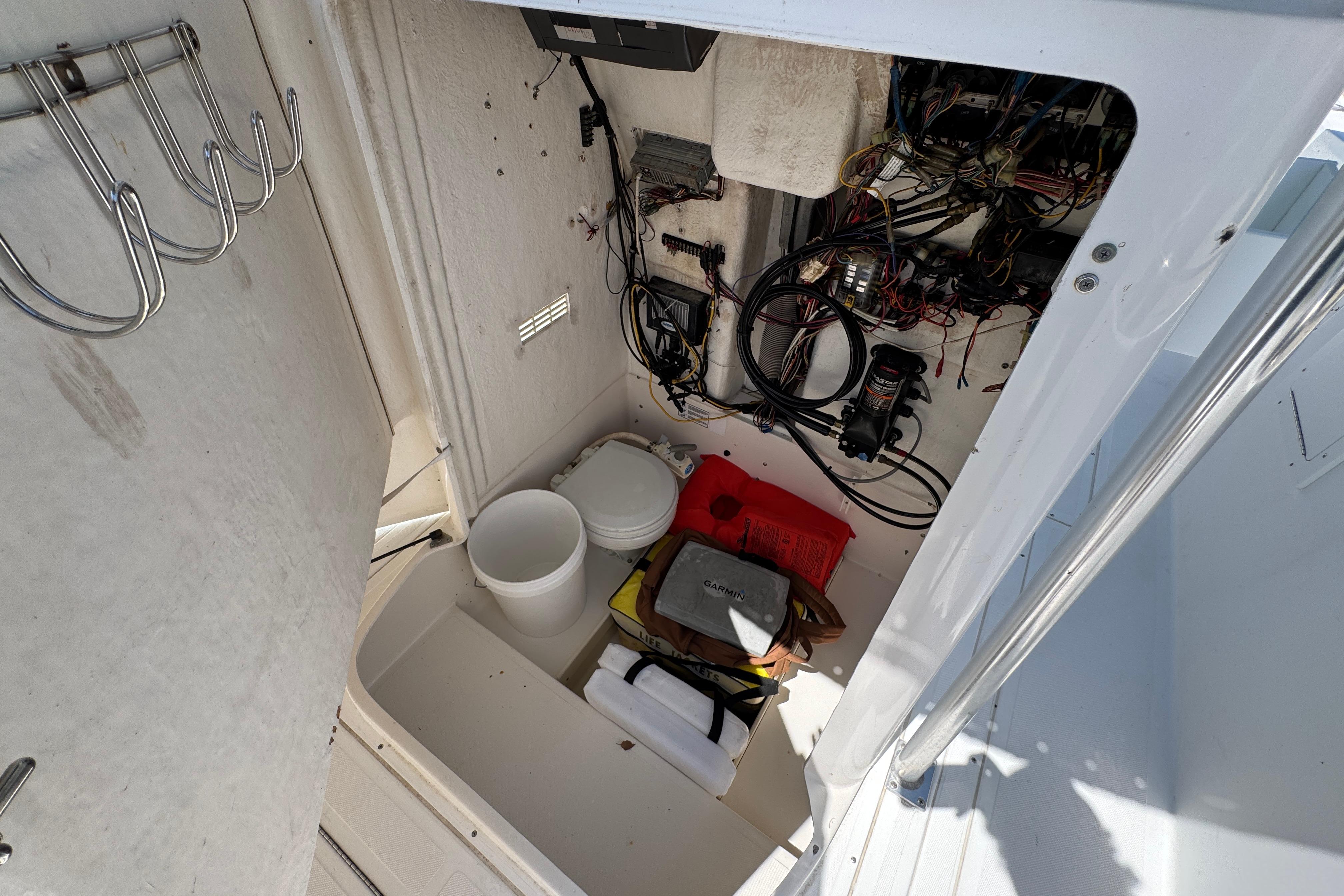 Storage compartment of a 2000 Stamas 250 Tarpon boat with wiring and equipment.