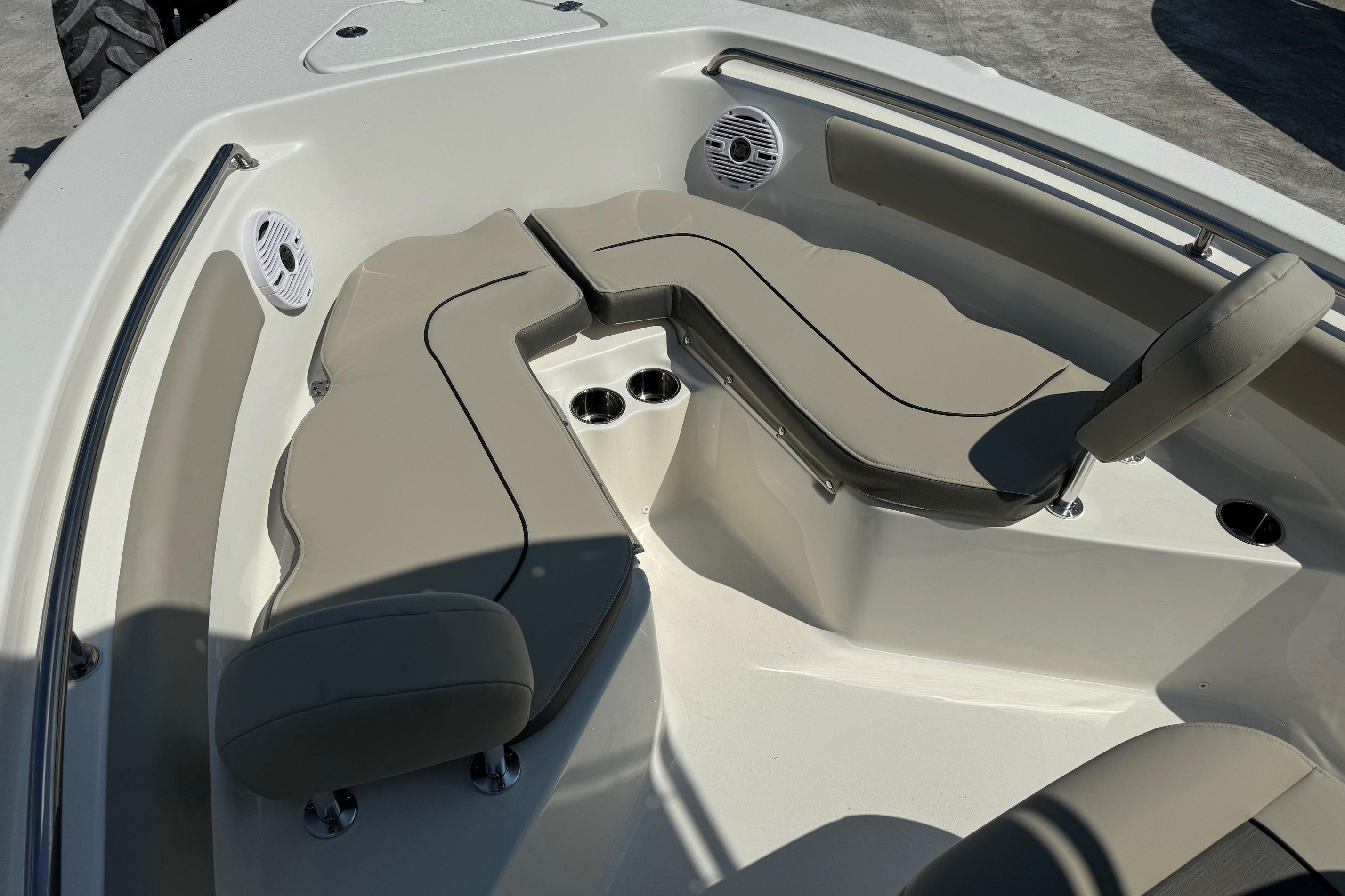 2025 Key West 203 FS boat interior with beige seating and cup holders.