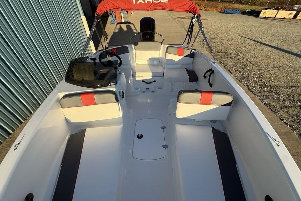 2026 Tahoe T16 boat interior with red accents and seating, docked outdoors.