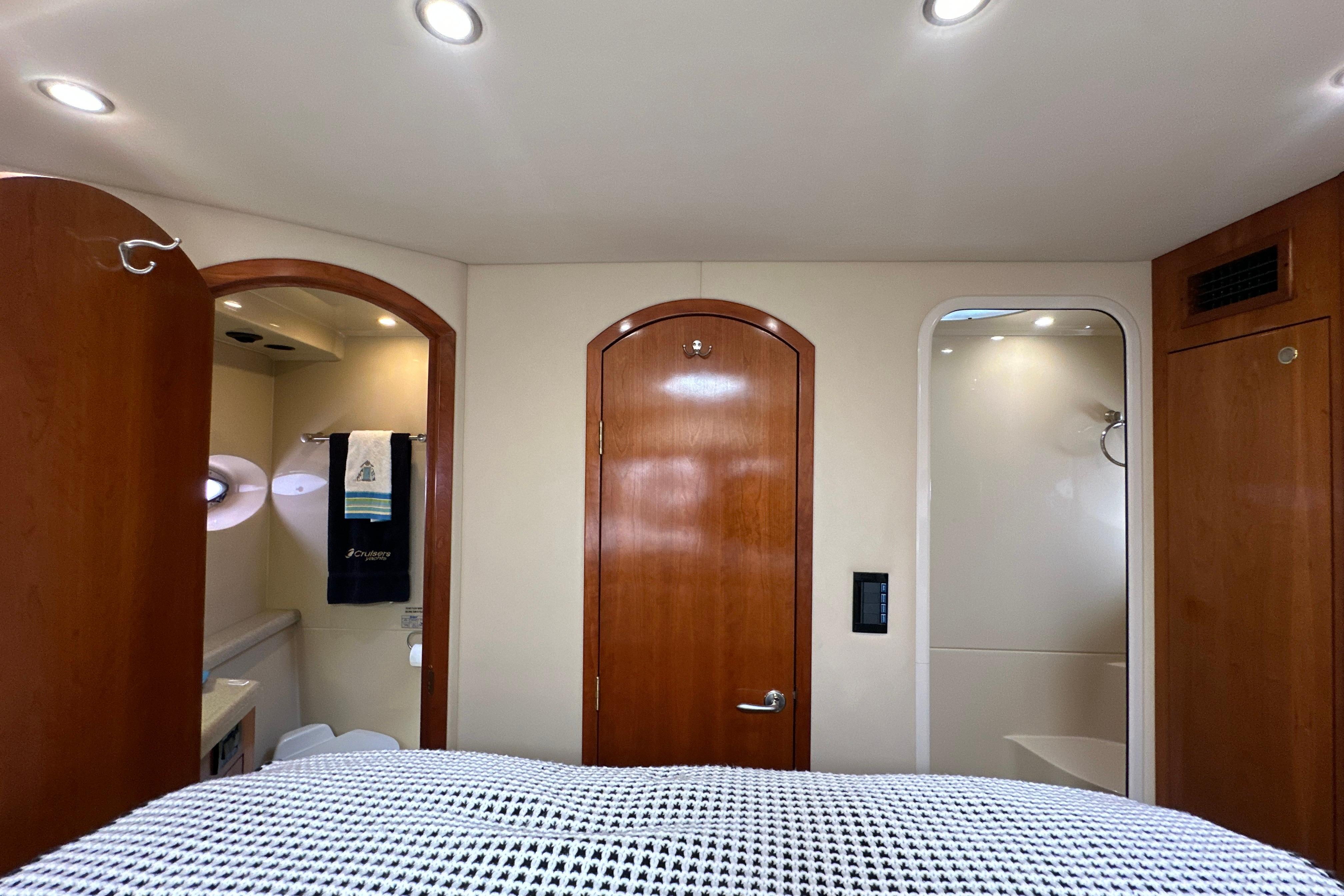 2004 Cruisers Yachts 405 Express Motoryacht interior with wooden doors and modern lighting.