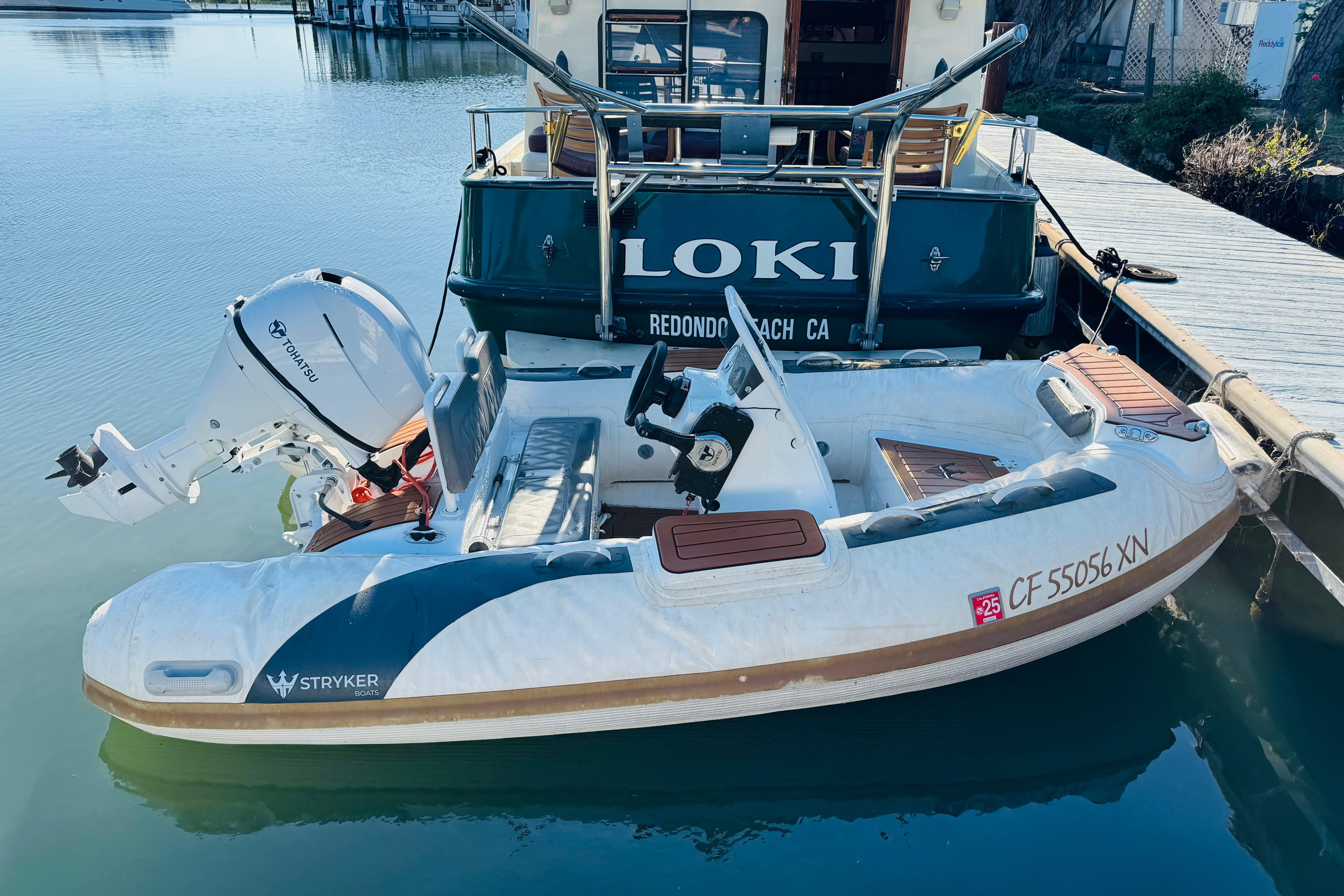 Nordic Tug 32 (1996) docked with inflatable boat, featuring Tohatsu outboard motor.