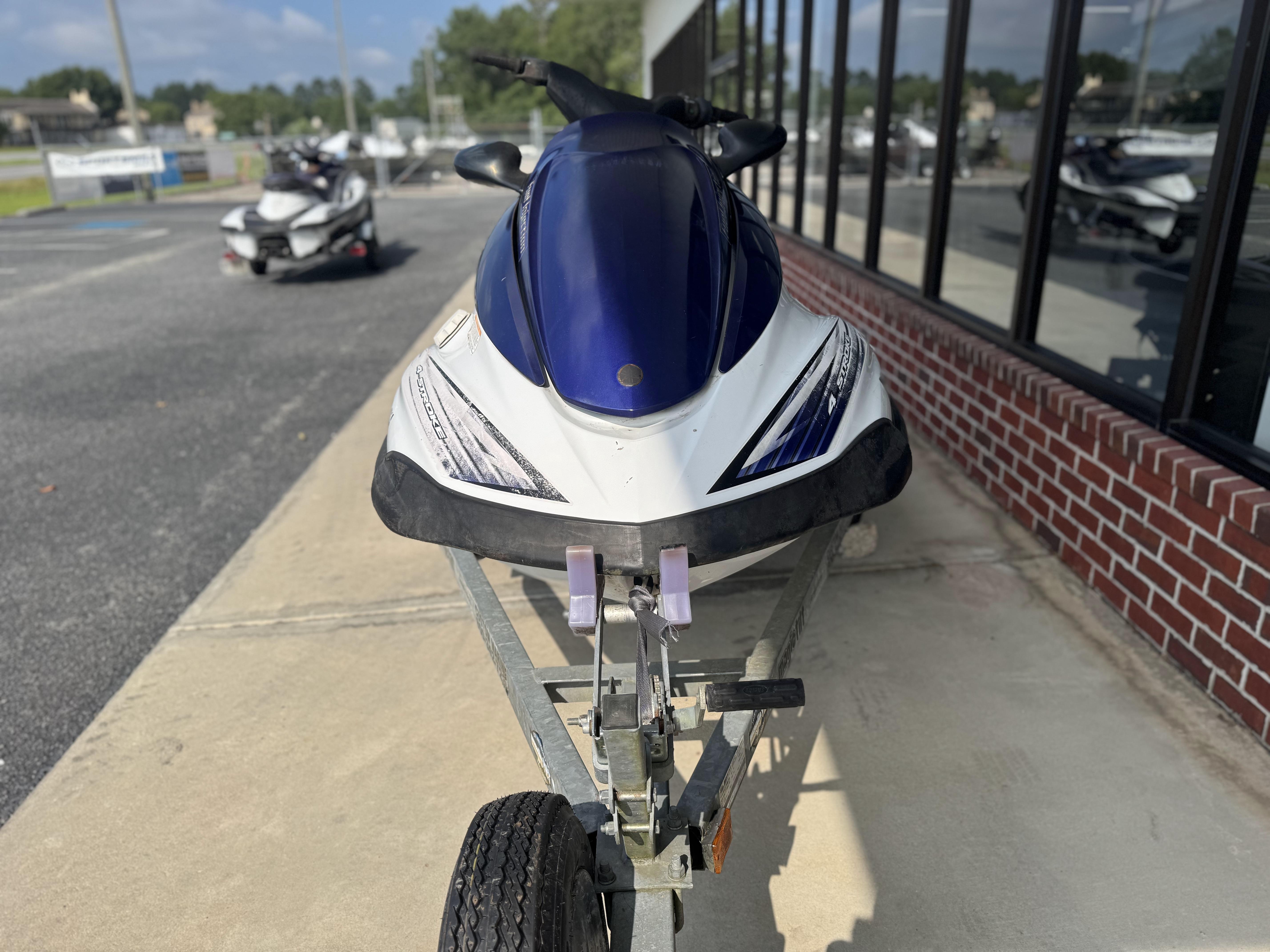 2003 Yamaha WaveRunner FX140 on trailer, parked outside a building.