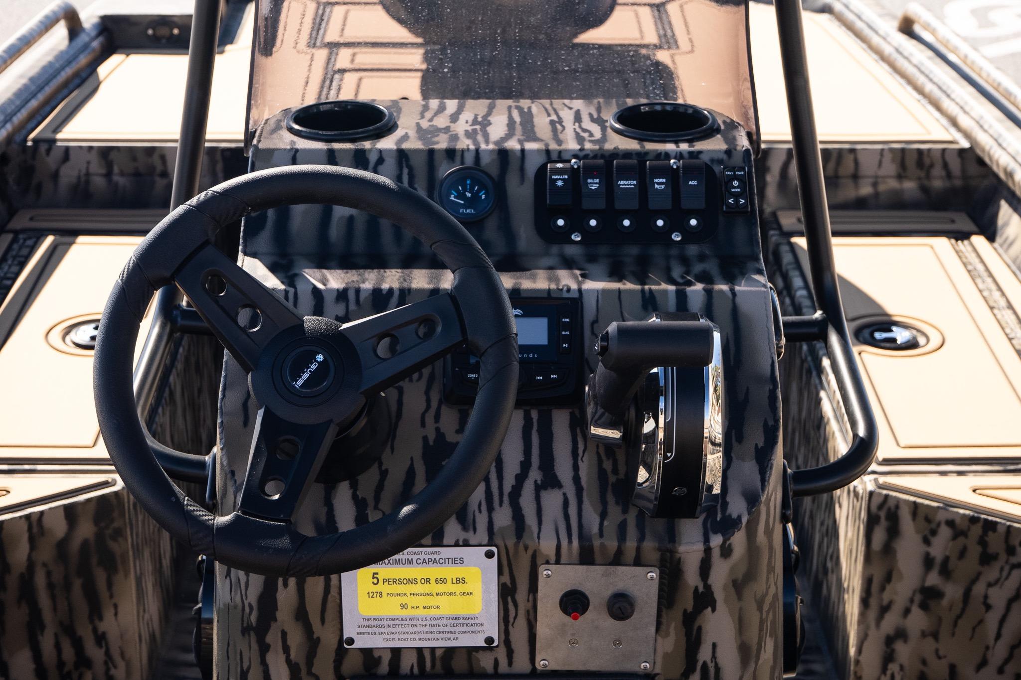 Steering console of 2026 Excel 1860 Shallow Water F4 CC boat with camouflage design.