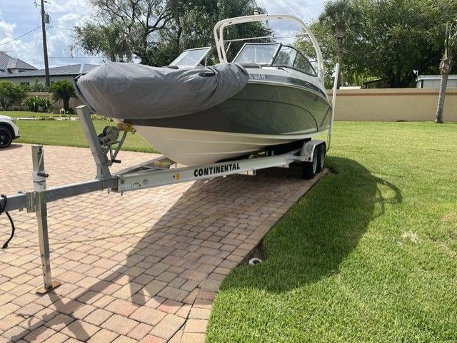 2015 Yamaha Boats 242 Limited S on Continental trailer parked outdoors.