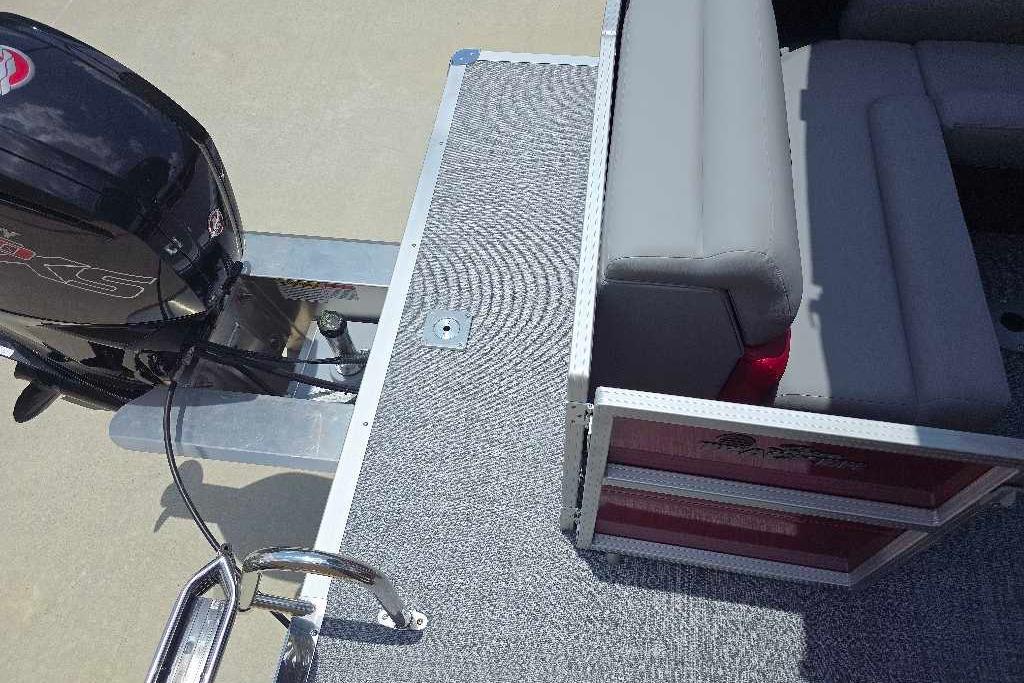 2026 Sun Tracker Party Barge 20 DLX with motor and seating area, top view.