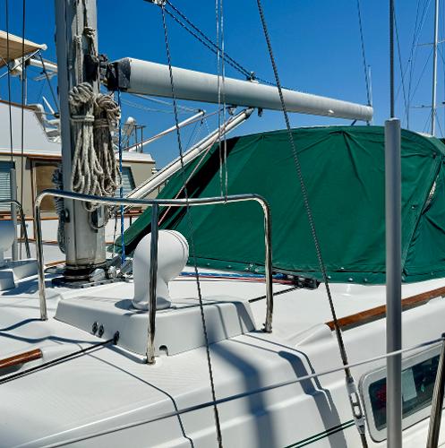 1996 Beneteau Oceanis 40 CC sailboat deck with green cover and rigging.