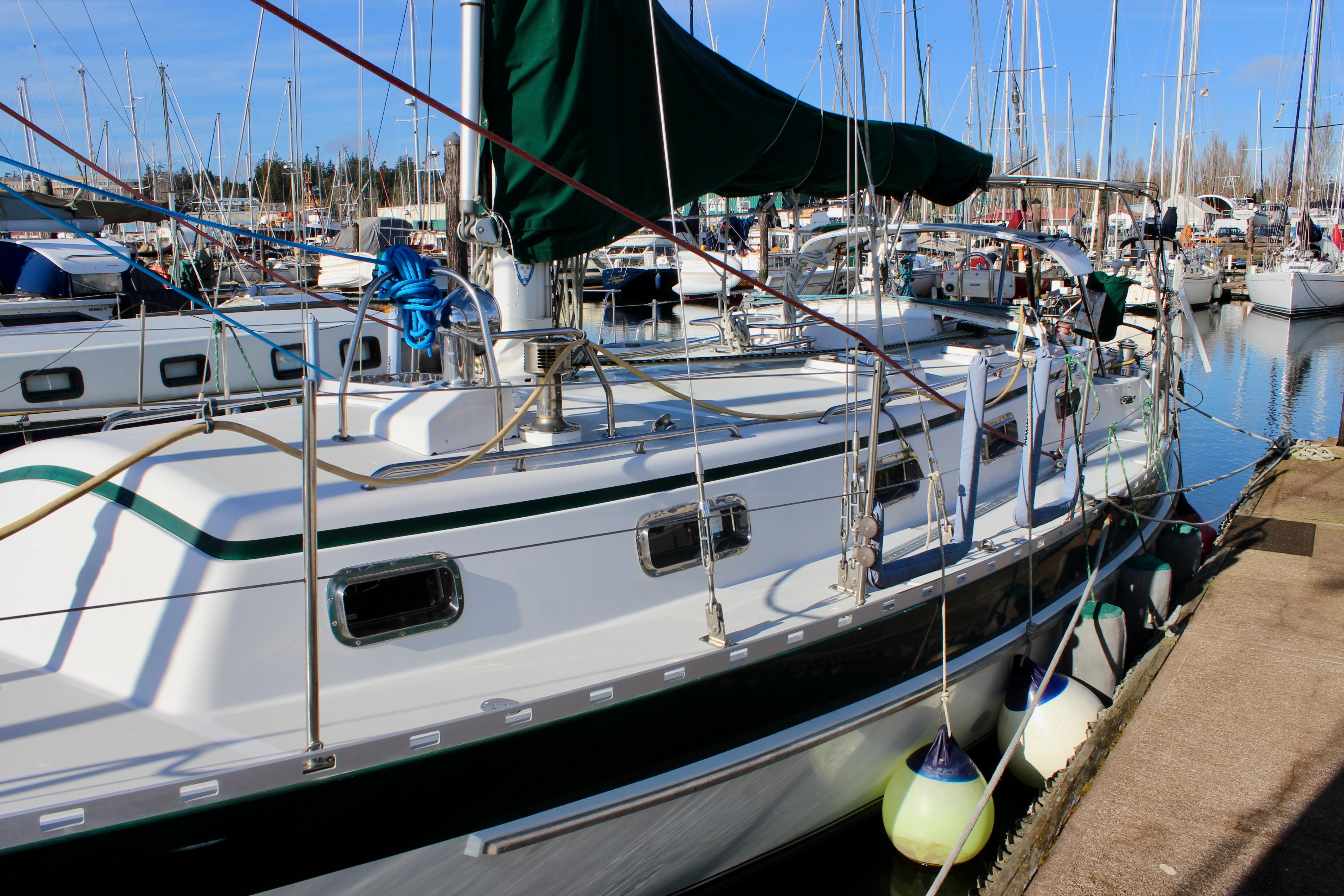 1997 Valiant 39 sailboat docked in a marina, surrounded by other boats.