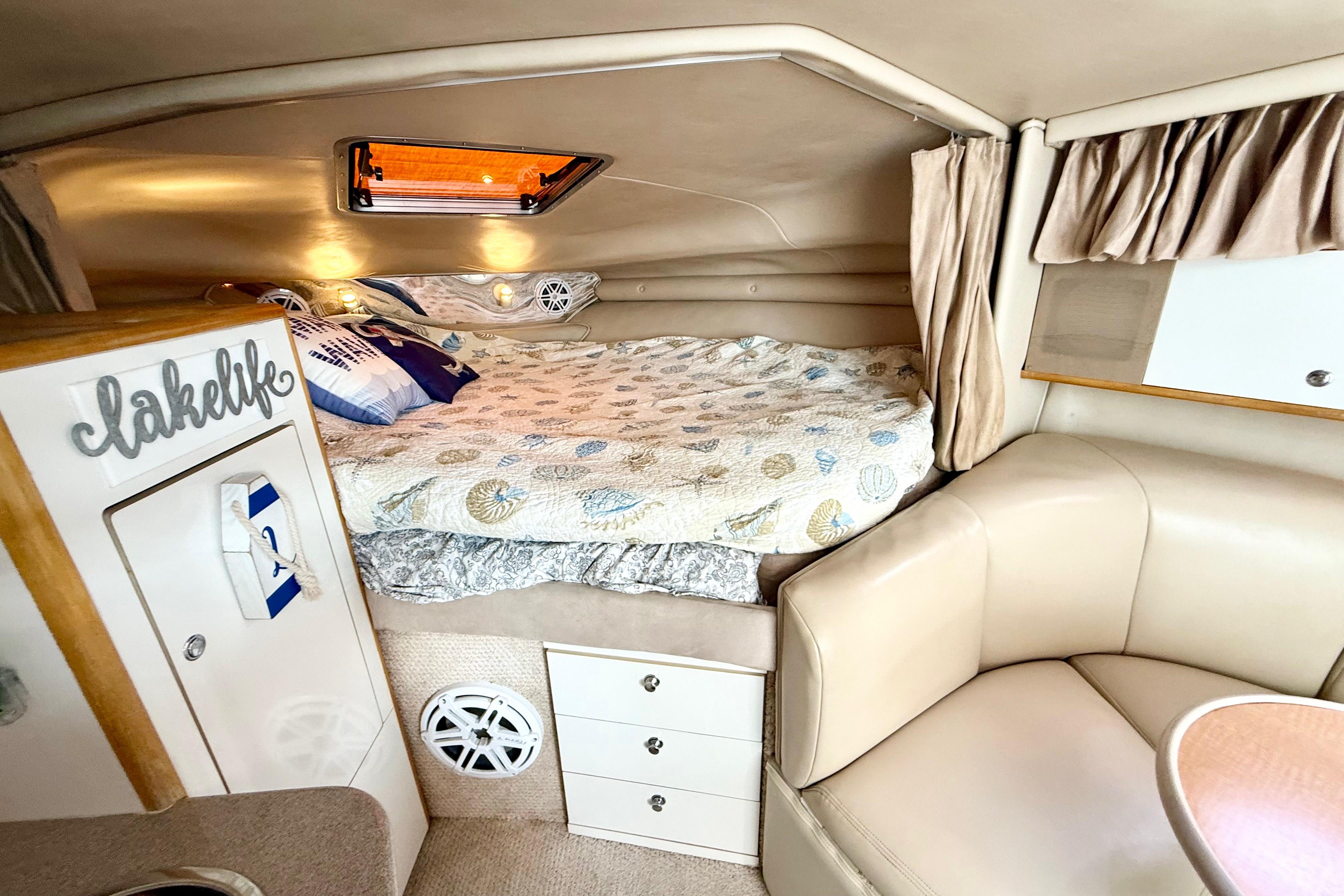 Interior of 1999 Chaparral Signature 300 boat with cozy bed and seating area.