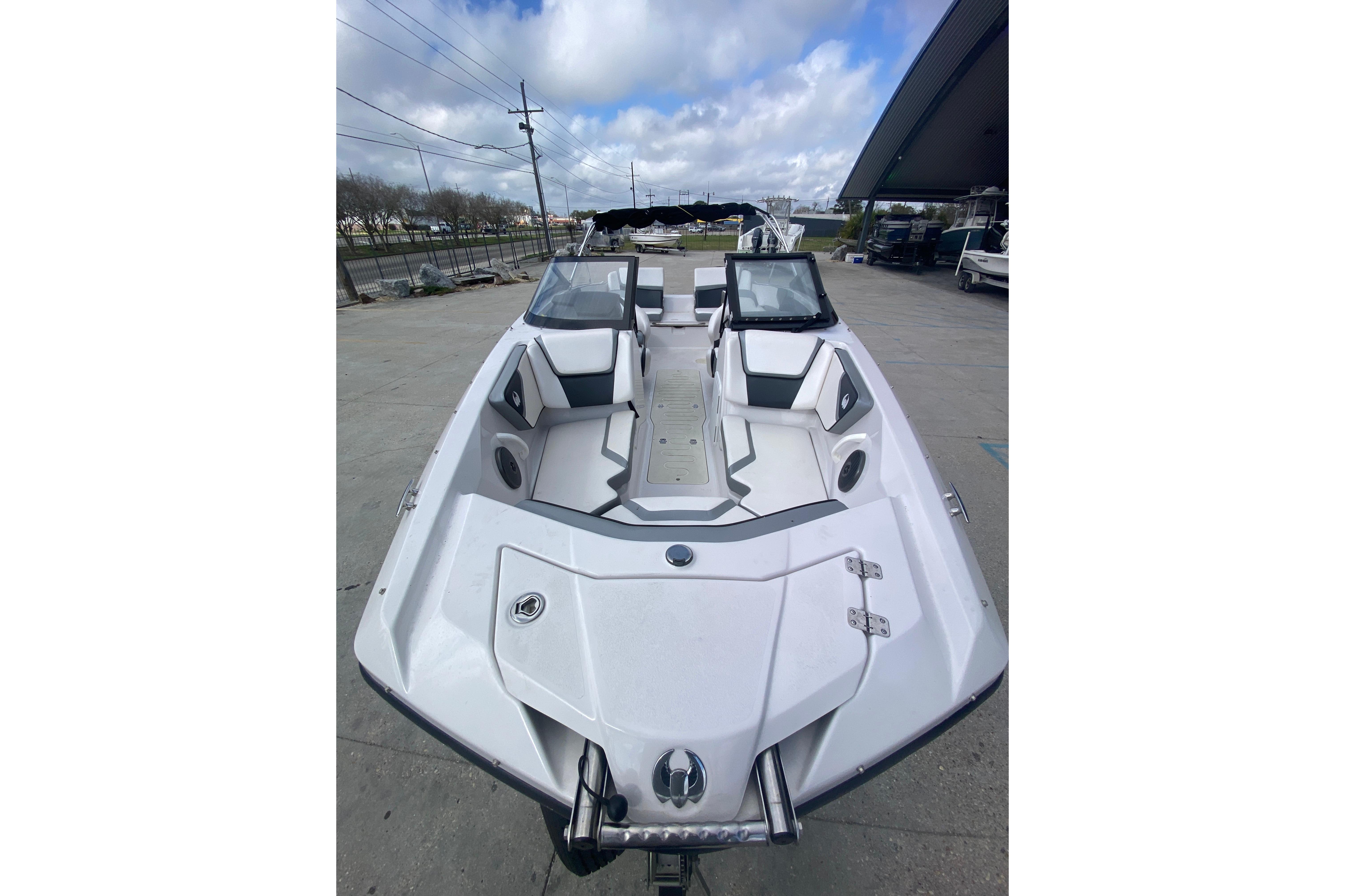 2018 Scarab 215 G boat with sleek design, white interior, and modern seating arrangement.