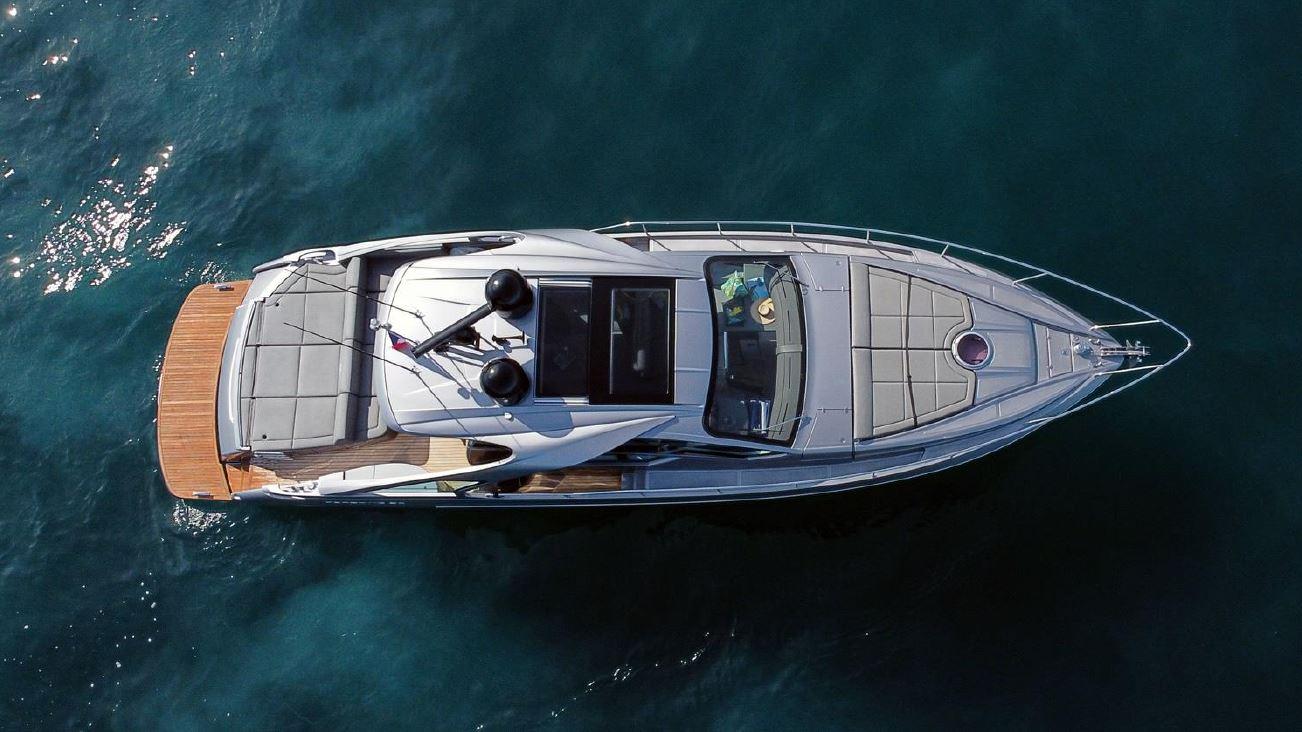 Overhead view of 2018 Pershing 5x yacht on clear blue water.