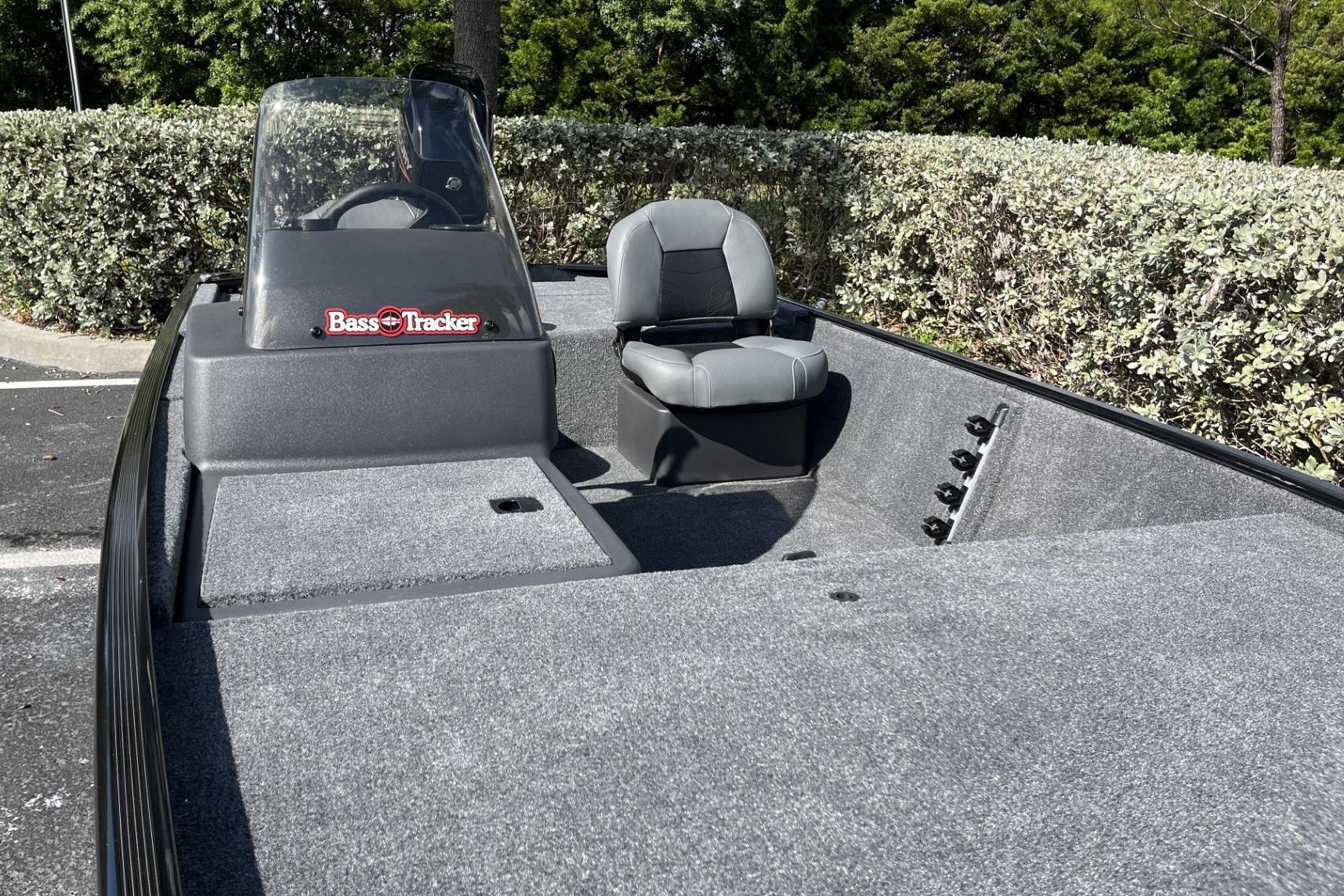 2026 Tracker Bass Tracker Classic XL boat with seating and console, parked outdoors.