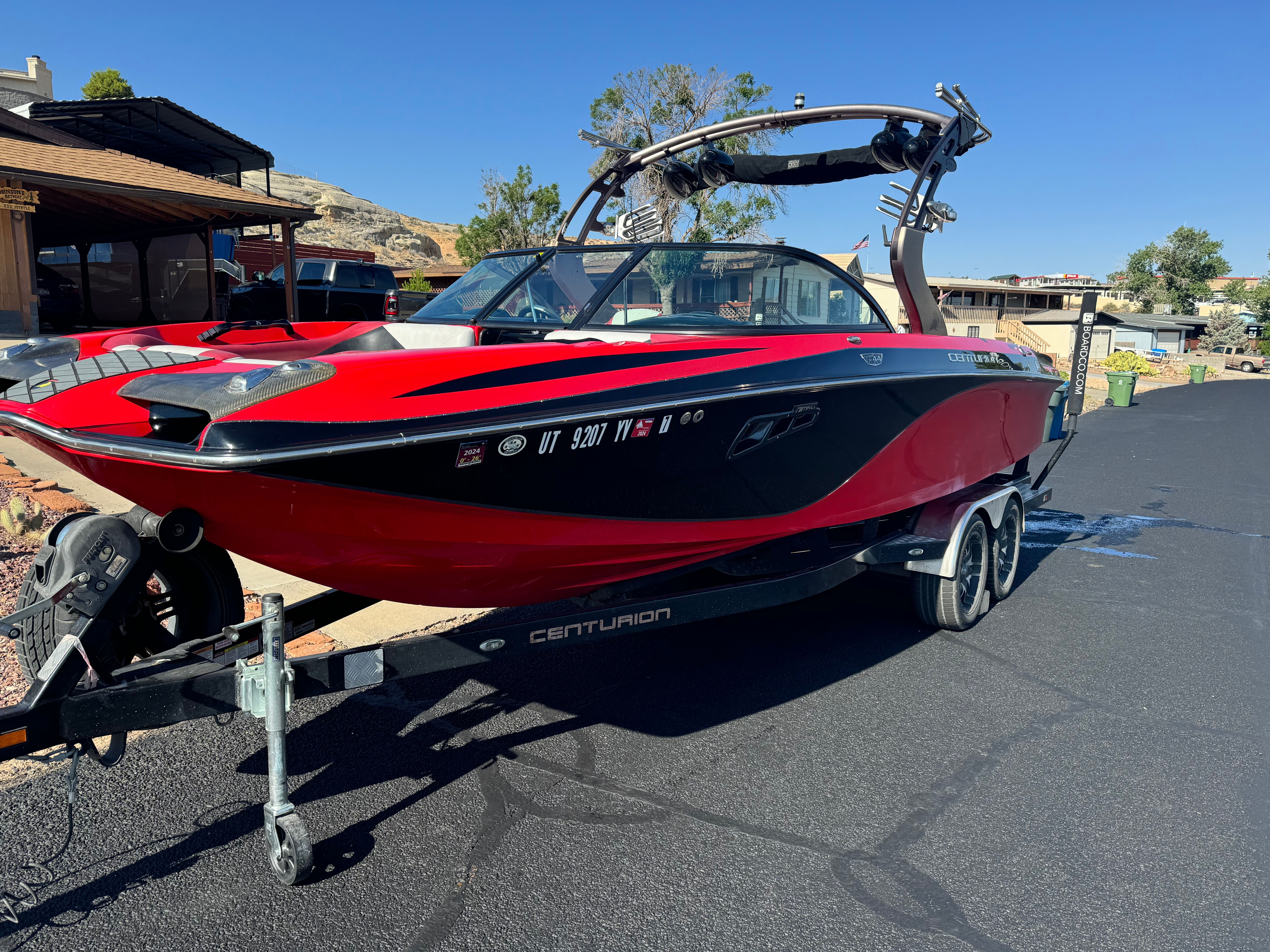 2014 Centurion Enzo FX44 boat on trailer, red and black, sunny day.