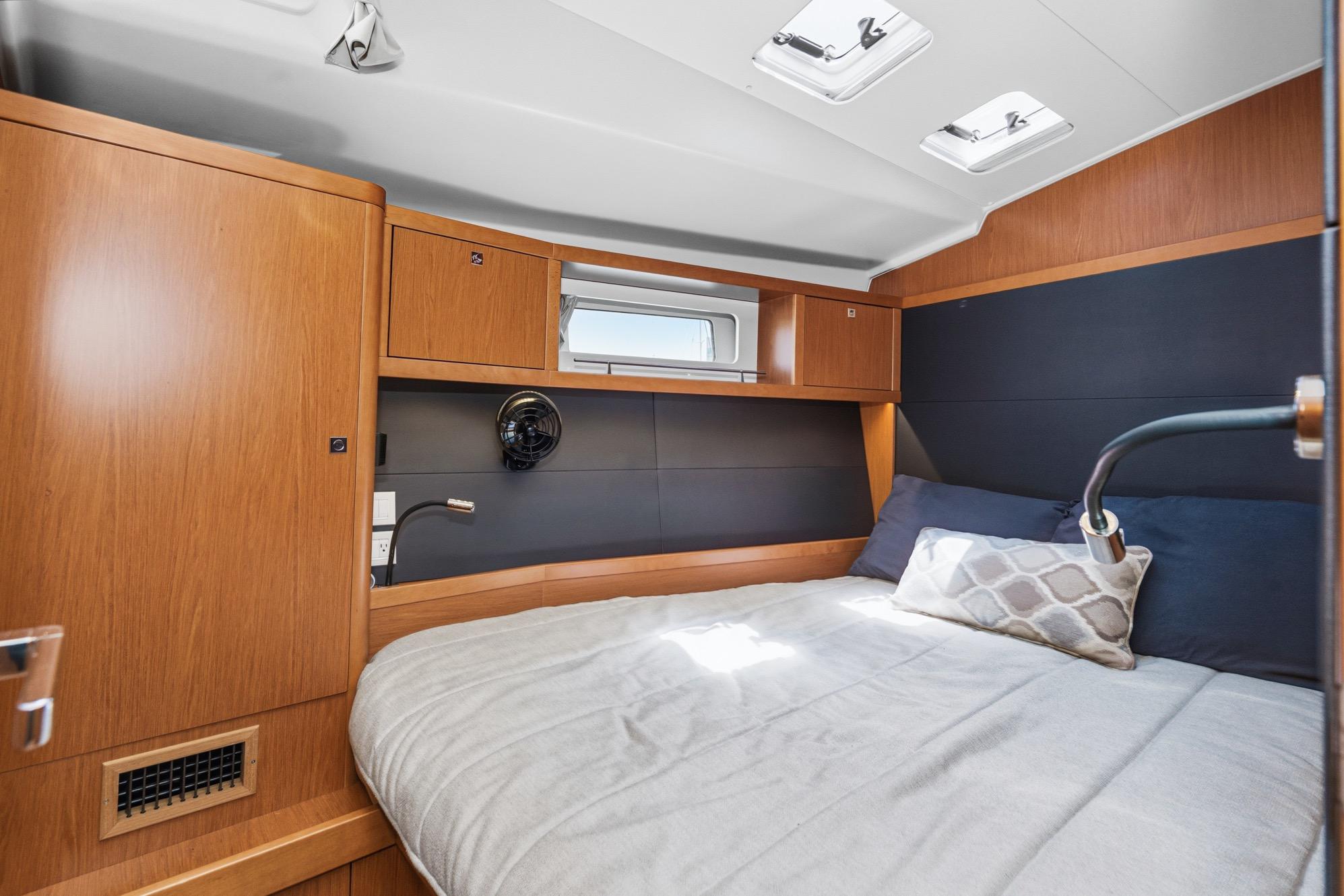 Cozy cabin interior of 2017 Beneteau Sense 50 yacht with modern wood finish.