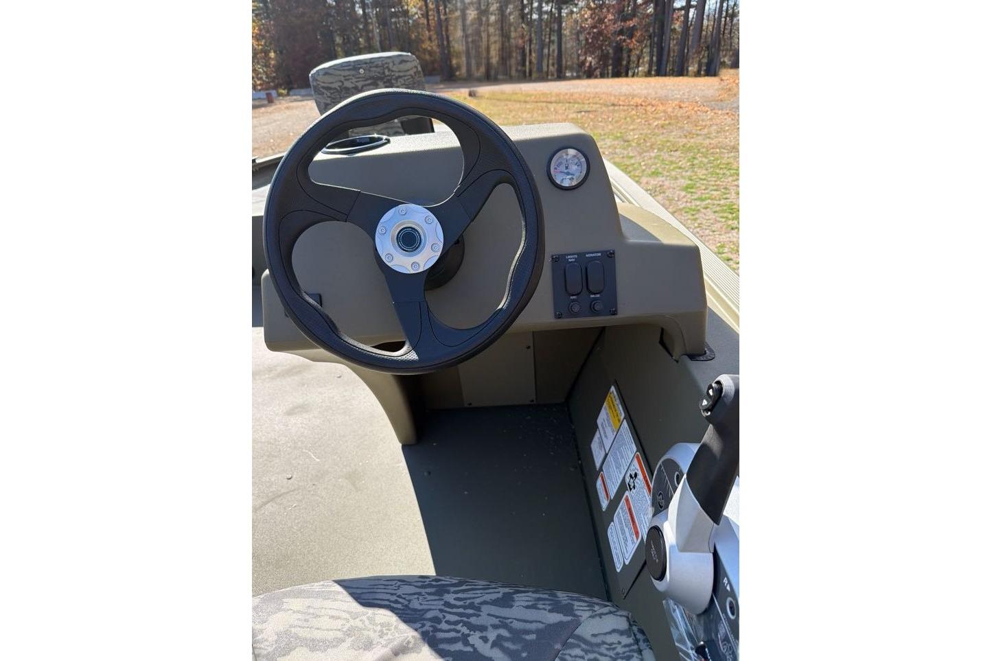 2026 Tracker Grizzly 1754 SC boat dashboard with steering wheel and controls.