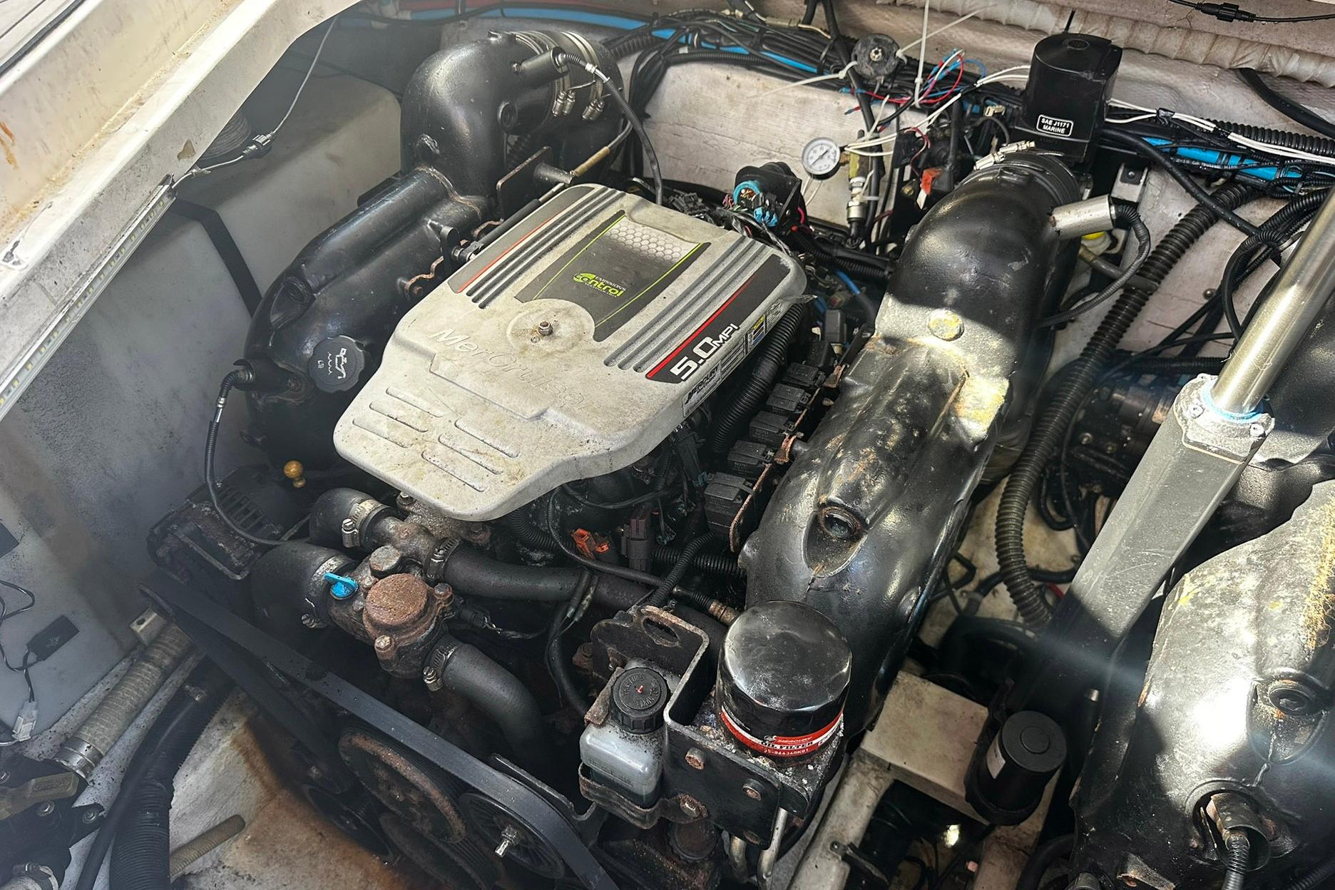Engine compartment of a 2012 Rinker 310 Express Cruiser LE boat.