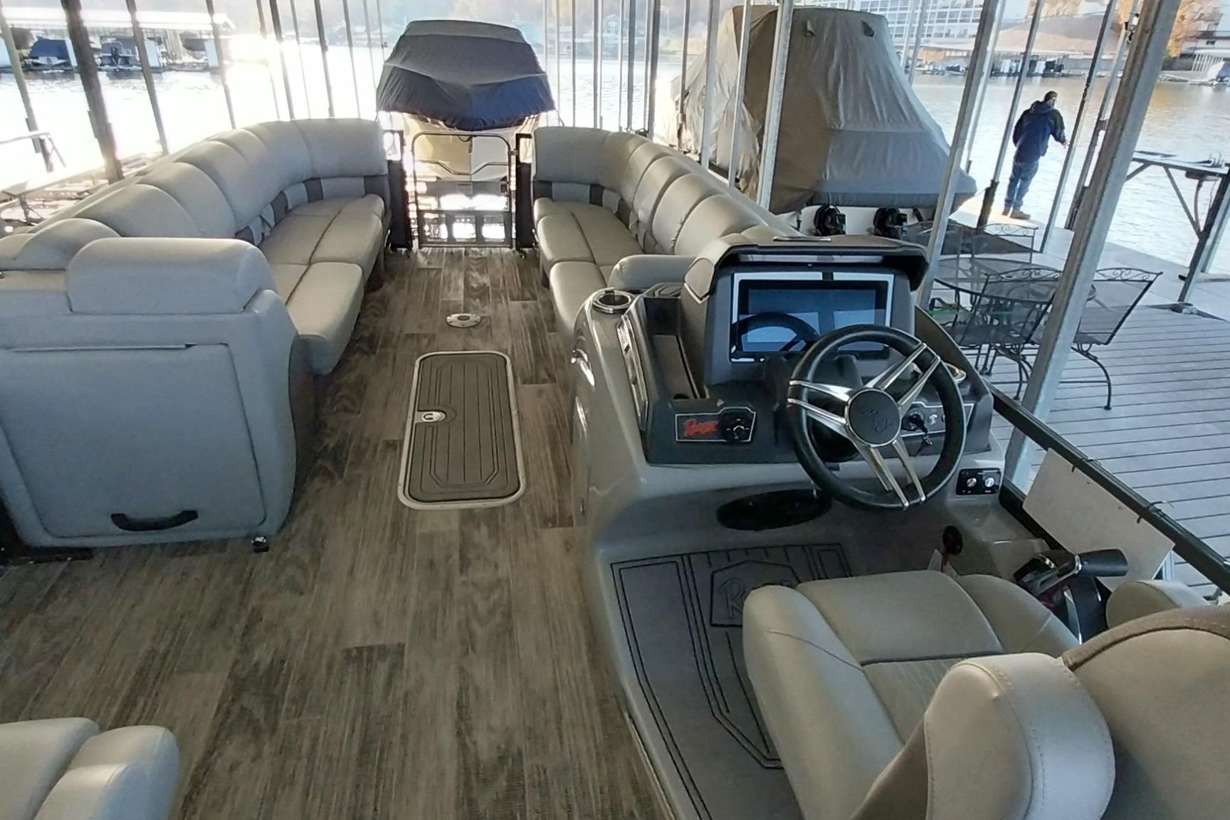 Luxurious 2023 Ranger 2500LS pontoon boat interior with plush seating and modern helm.