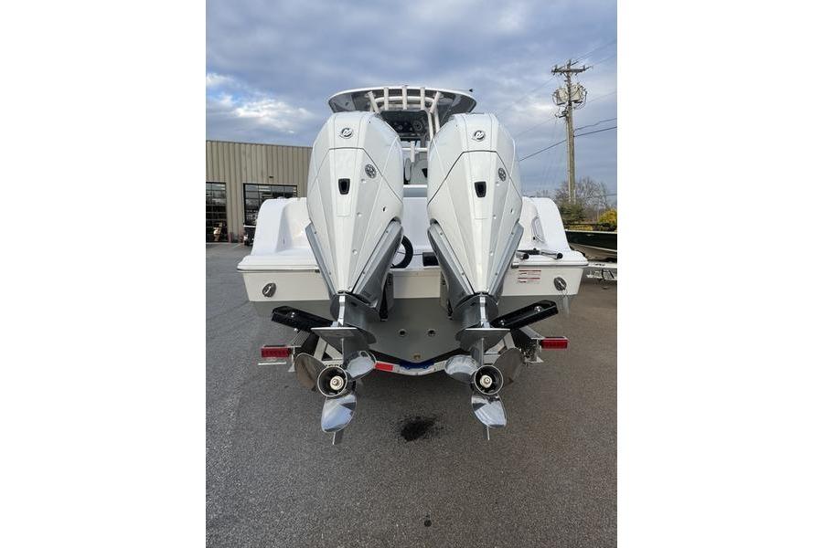 2026 Sportsman Open 282 Center Console with dual outboard engines, rear view.