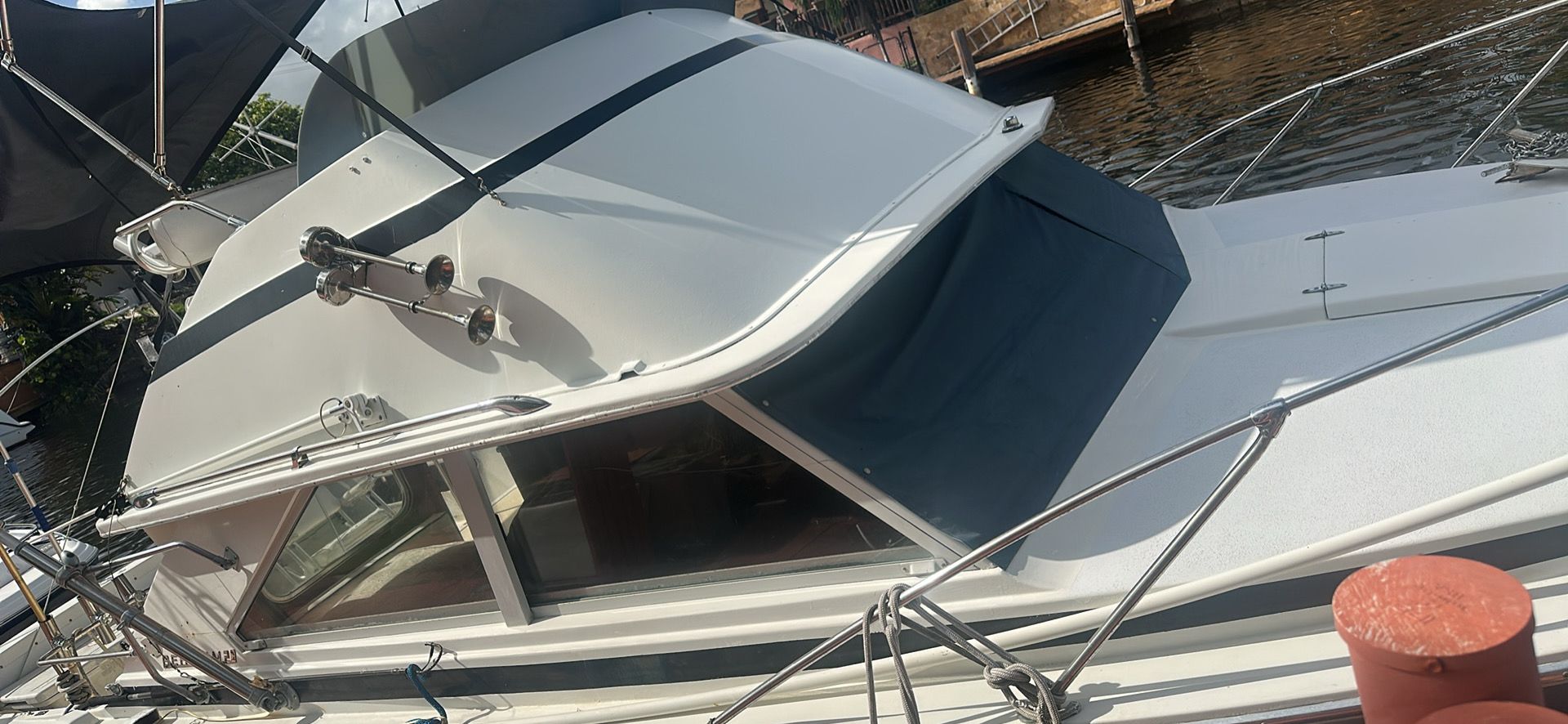1974 Bertram 28 boat docked, side view.