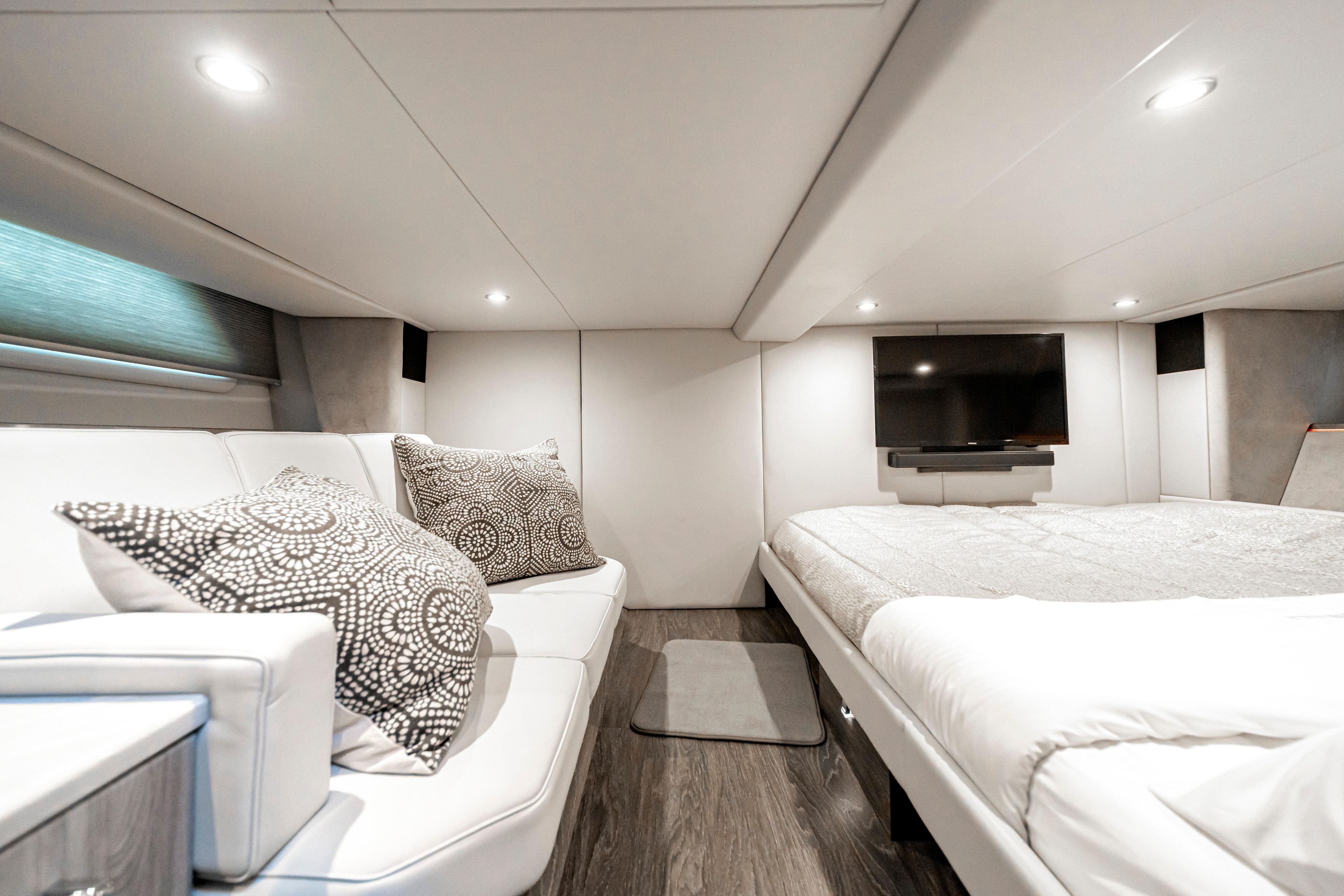 Luxurious interior of 2022 Formula 500 Super Sport Crossover with modern bedding and seating.