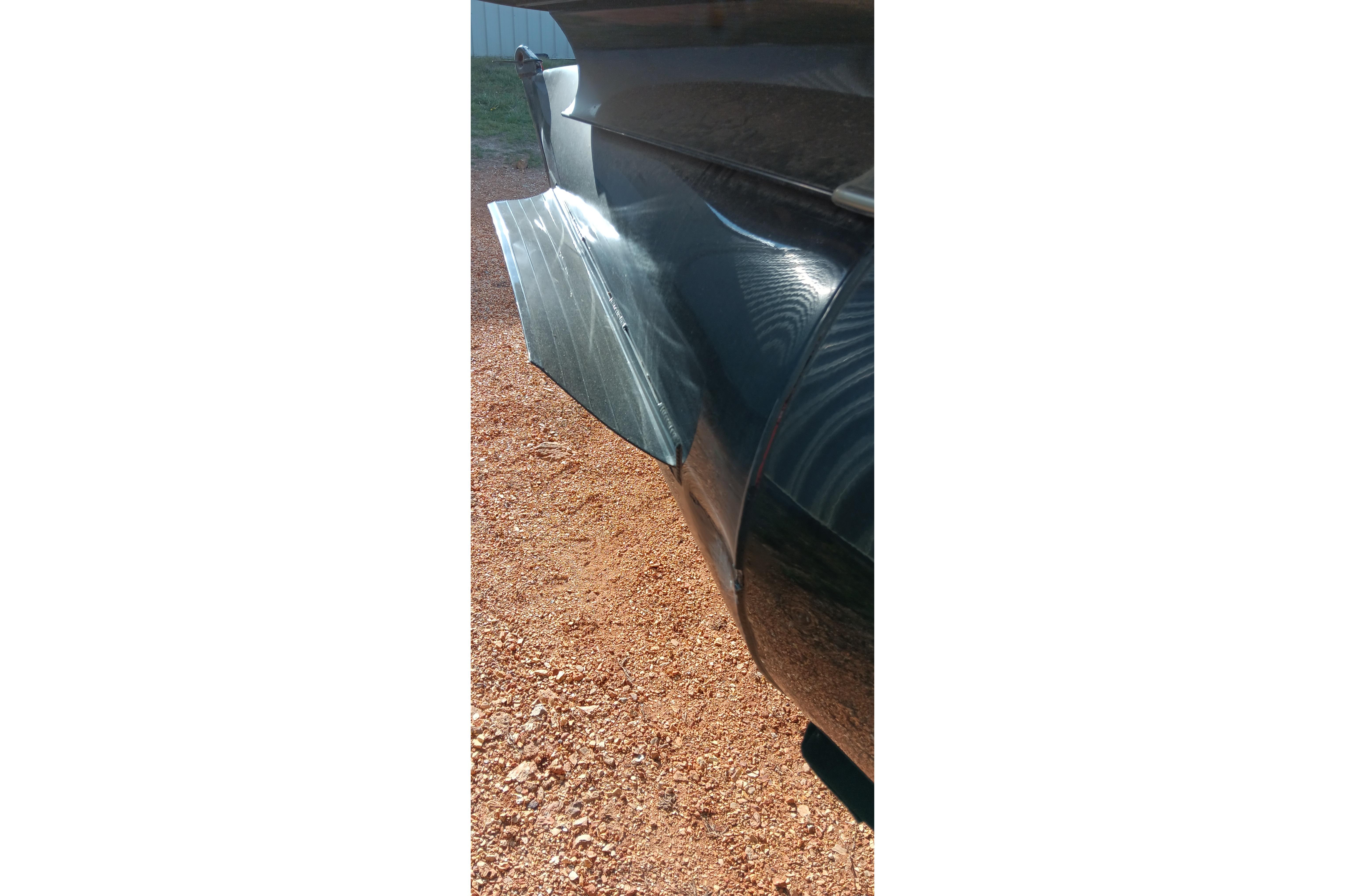 Close-up of a 2023 Ranger 2500LS boat hull on gravel surface.