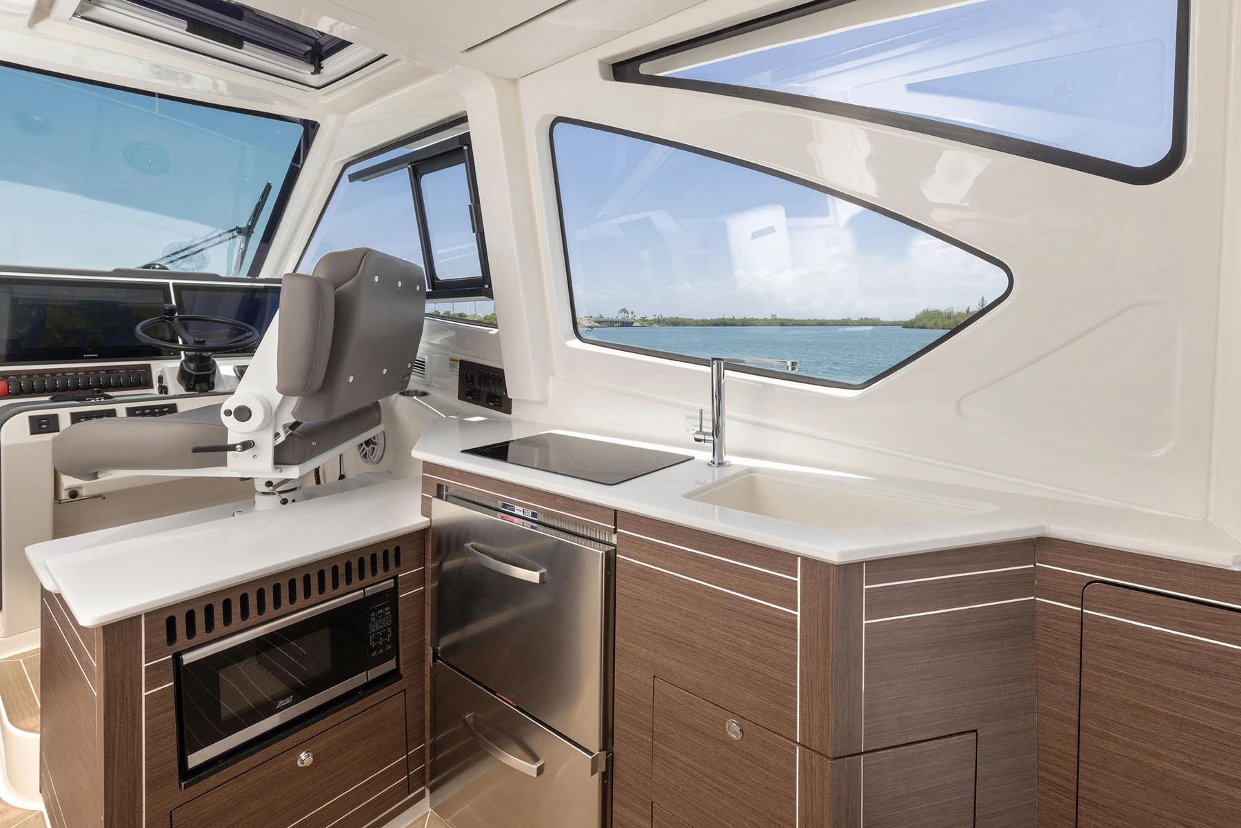 Manufacturer Provided Image: 2025 Pursuit OS 445 Offshore interior with modern kitchen and ocean view.
