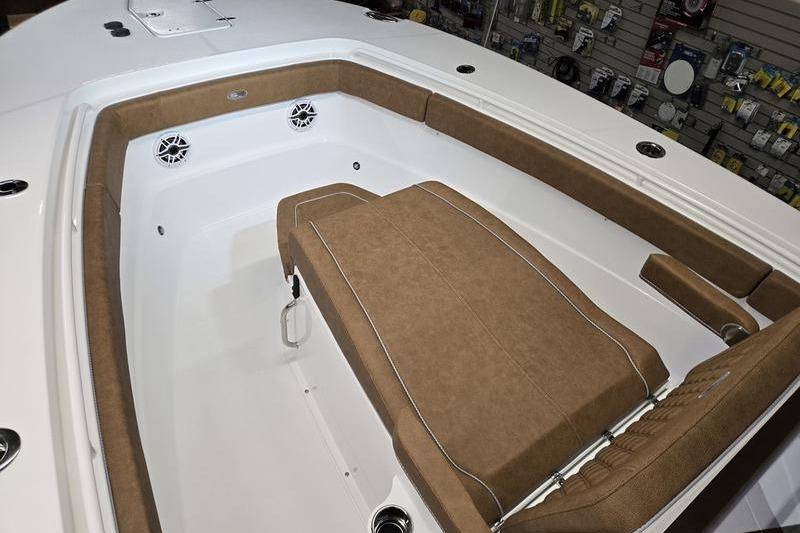 2026 Sea Hunt Ultra 275 Coffin Box boat interior with brown cushioned seating.