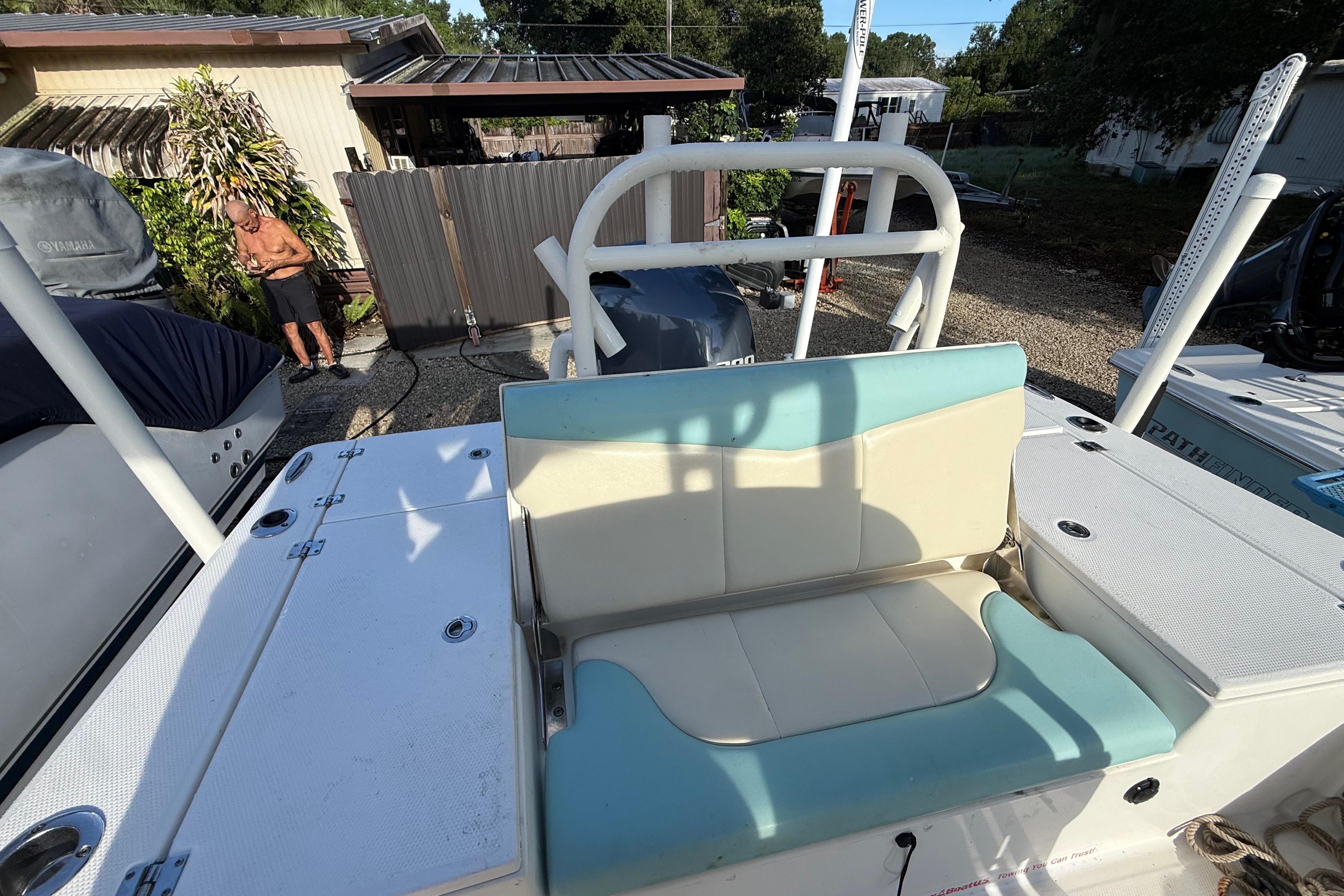 2017 Robalo 226 Cayman boat with teal and cream seating, parked outdoors.