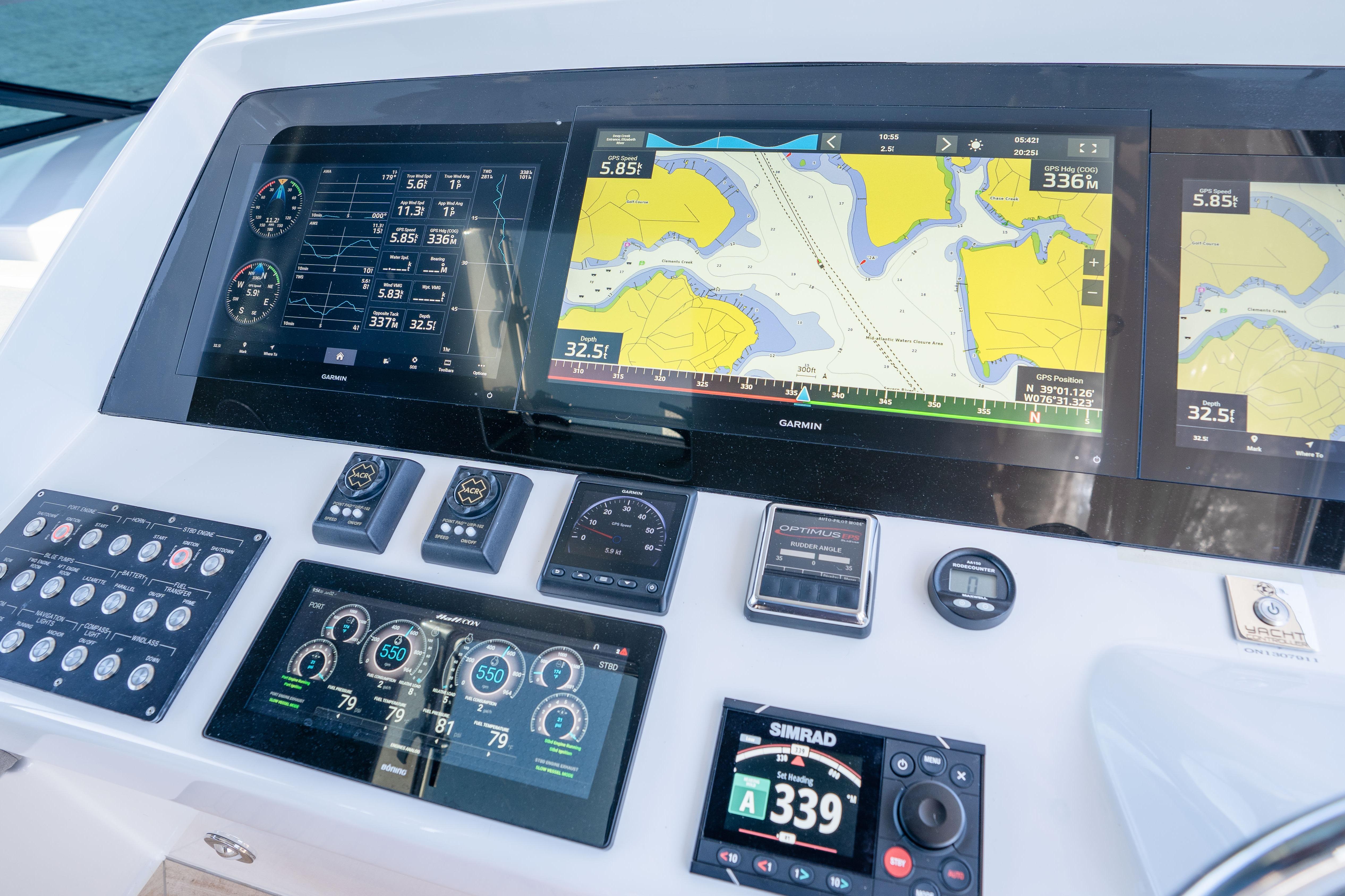 Helm dashboard of 2021 Hatteras M75 Panacera with navigation and control displays.