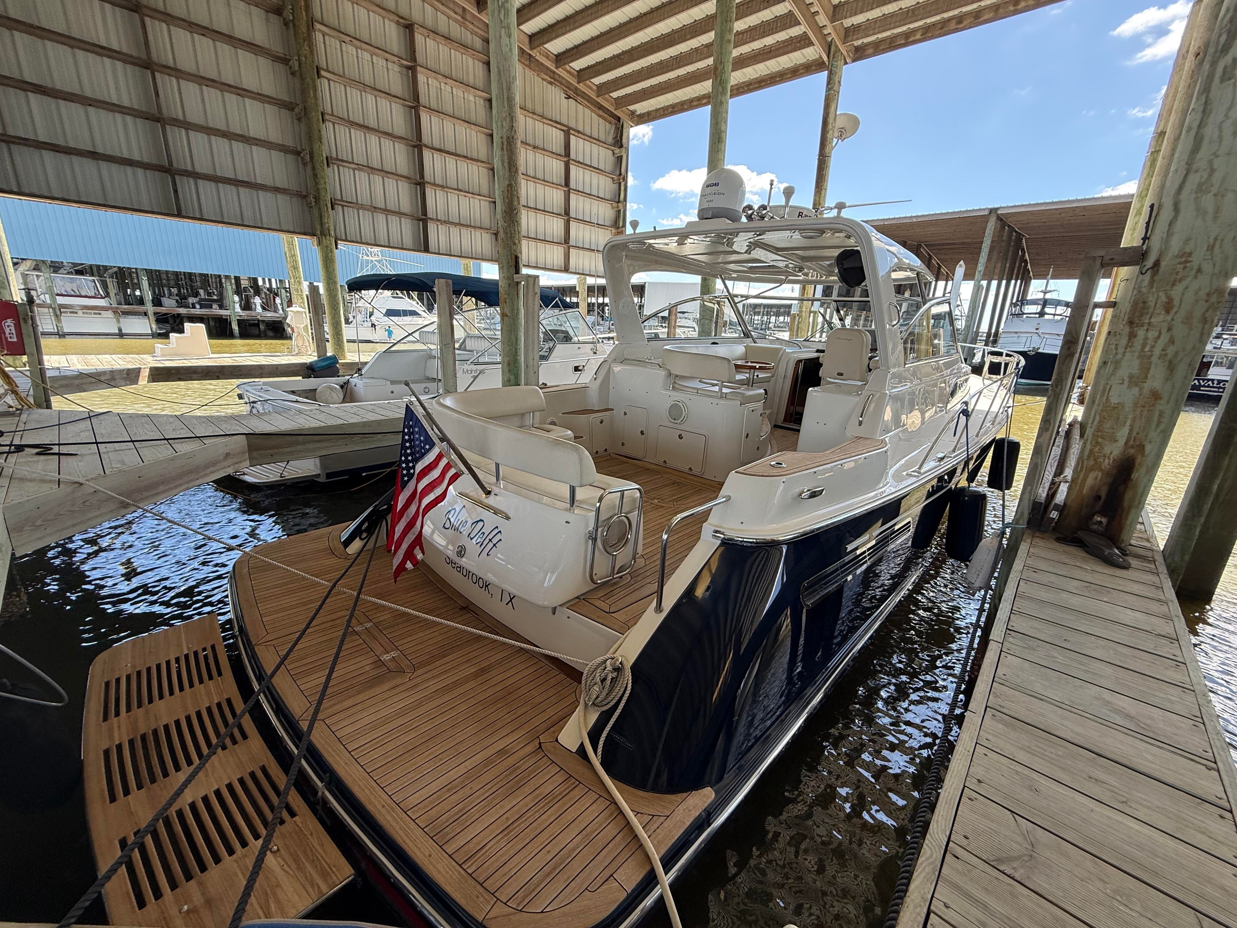 2007 Chris-Craft Roamer 40 docked in a covered boathouse.