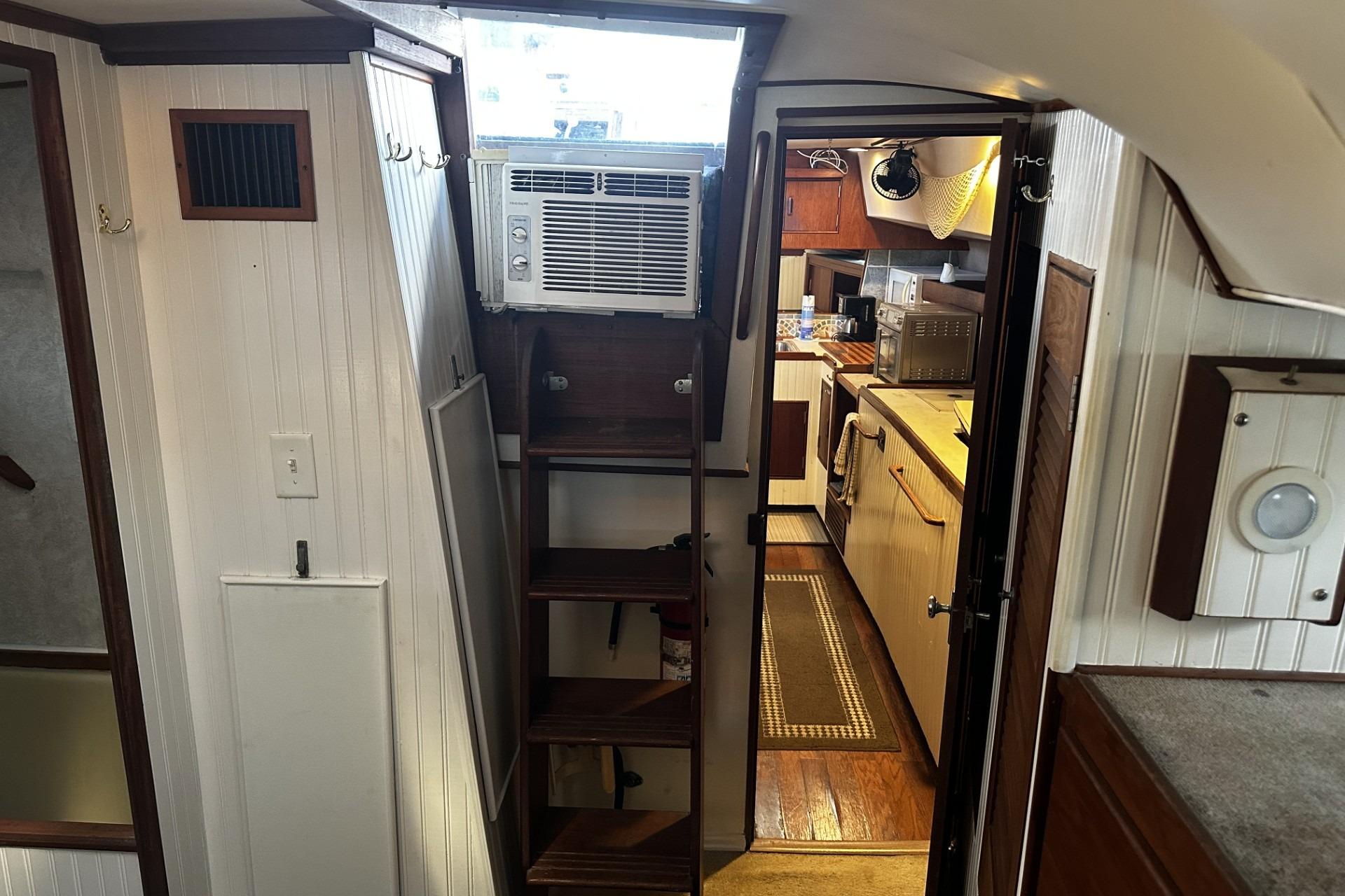 Interior of a 1975 Morgan Out Island 51 yacht with kitchen and air conditioning unit.