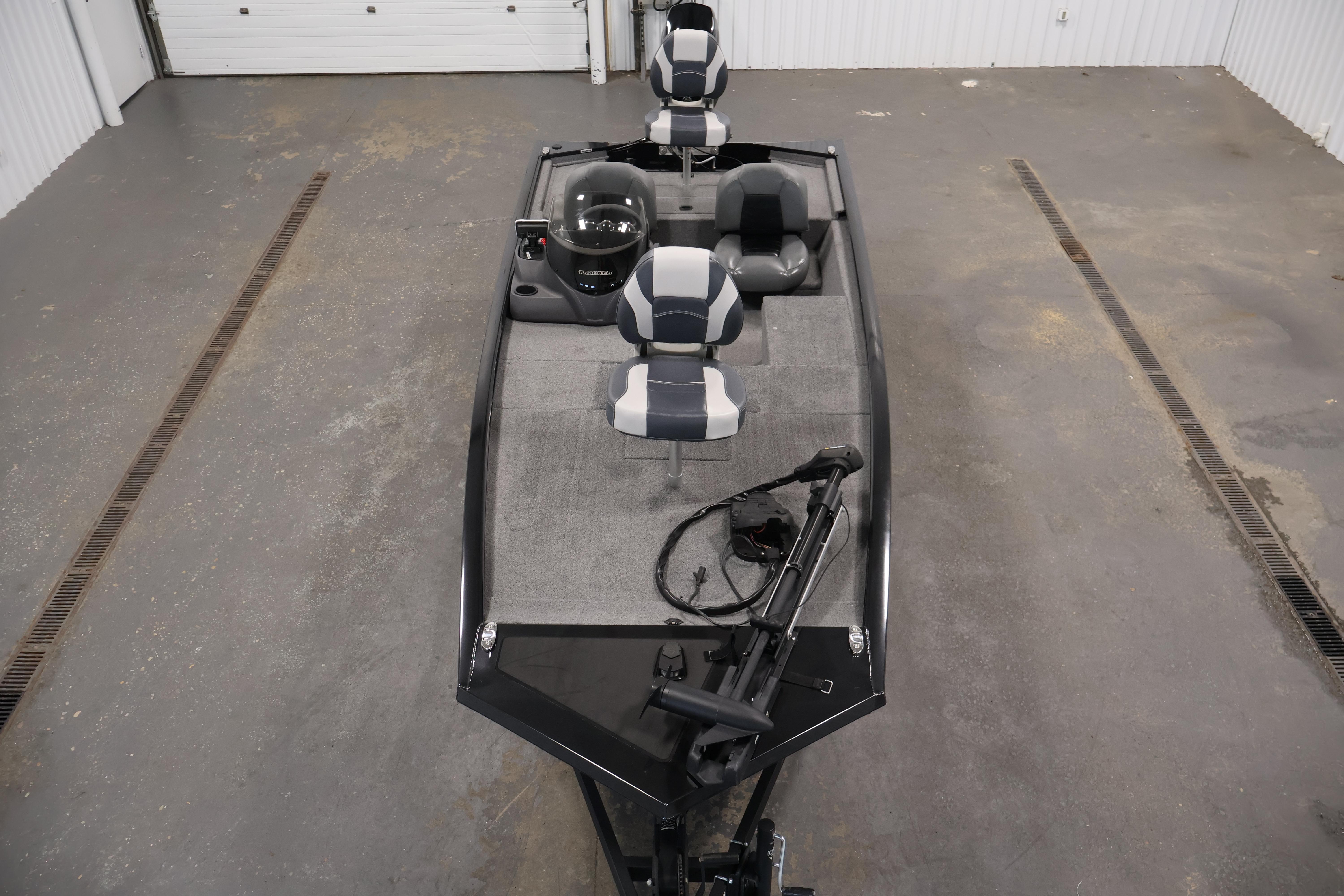 2024 Tracker Pro 170 boat interior with seating and steering console in a garage setting.