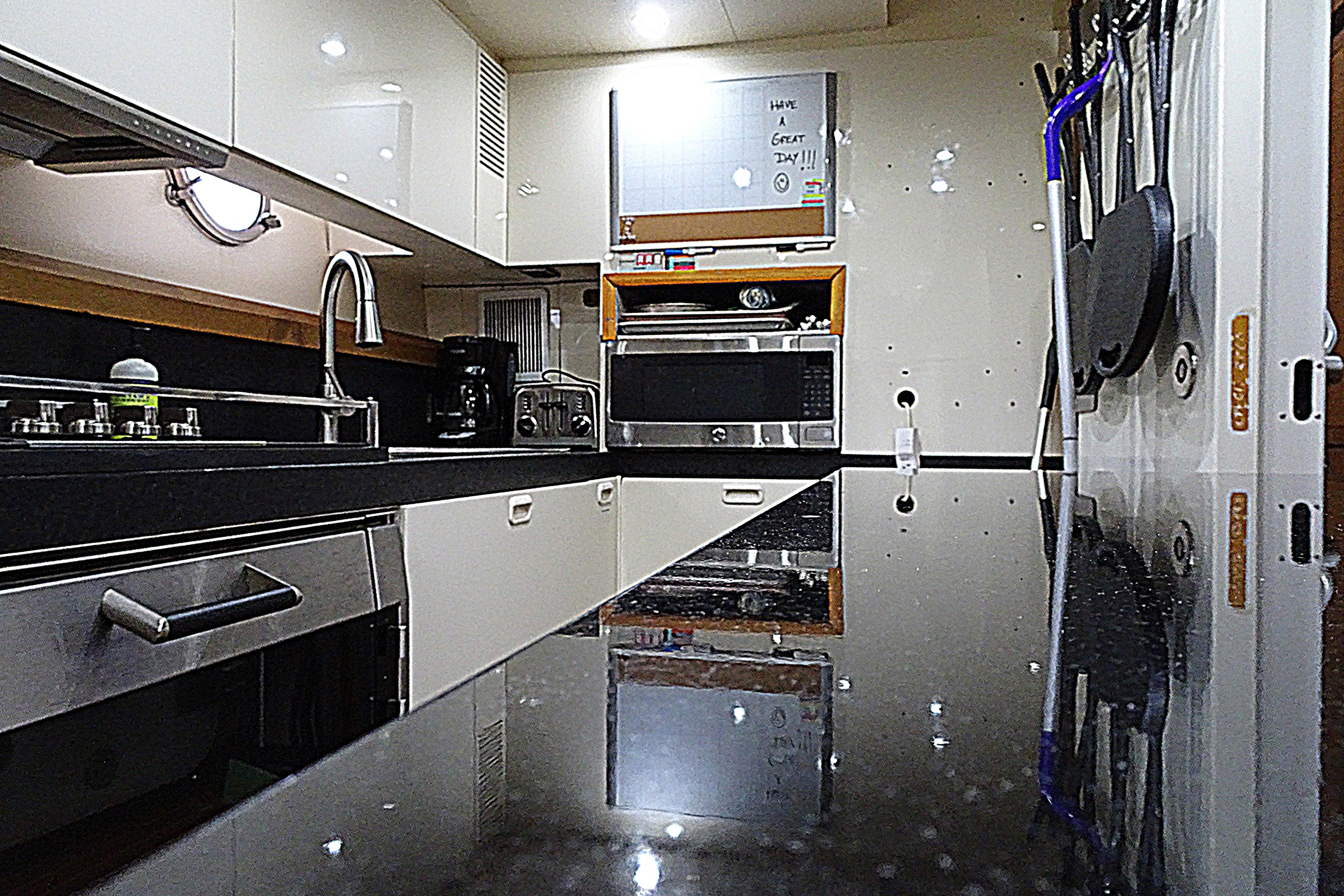 Luxurious kitchen interior of 2010 Azimut 100 Leonardo yacht with modern appliances.
